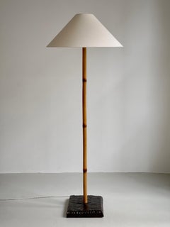Rare Finnish 1960s floor lamp in patinated bamboo rattan and stained oak base.