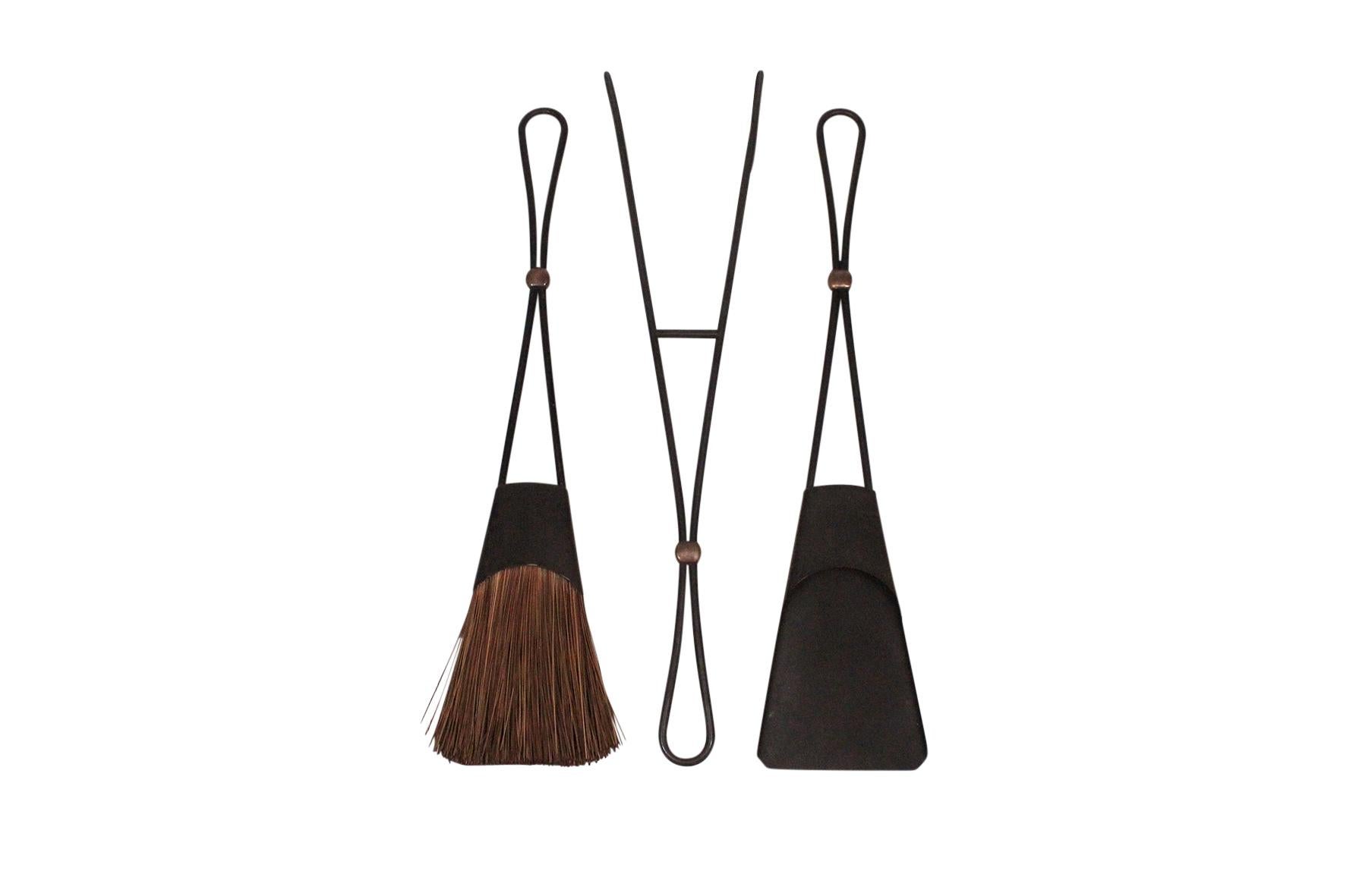 Set of 3 modernist fireplace tools with a wall-mounted rack by Jens Harald Quistgaard for Dansk. Denmark, 1950s.