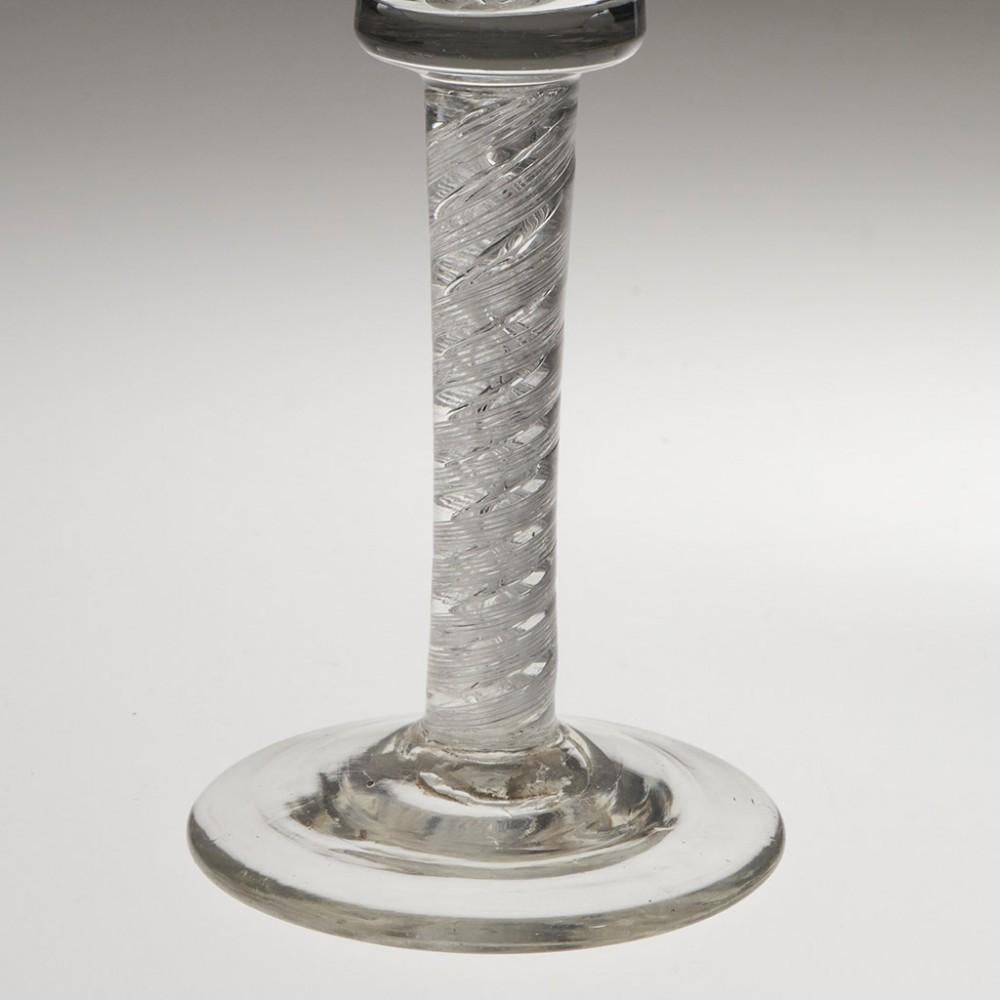 Heading : Double series air twist stem Georgian wine glass
Period : George II - c1750
Origin : England
Colour : CLear
Bowl : Waisted flared bucket
Stem : A pair of six-ply spiral bands outwith a pari of corkscrews
Foot : Conical
Pontil :