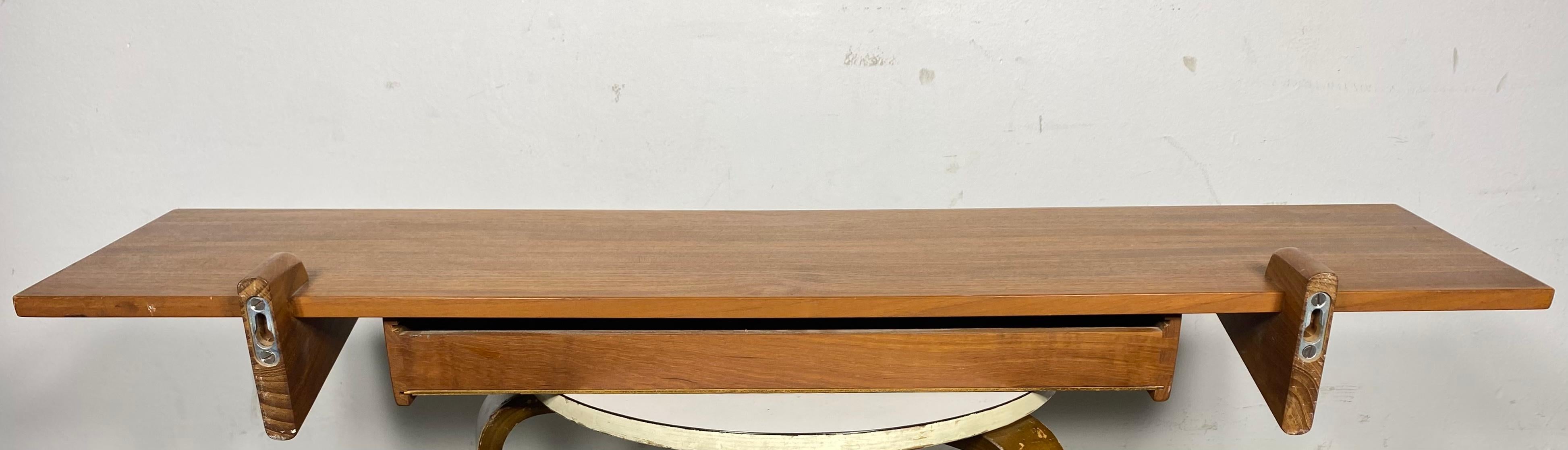 Rare Floating Teak Shelf by Aksel Kjersgaard / 1960's Mid Century Danish Design.
Incredibly lovely and rare teak drawer shelf by Aksel Kjersgaard. Made in Odder Denmark c. 1960's. Quintessential Danish design utilizing a unique wall mounted shelf