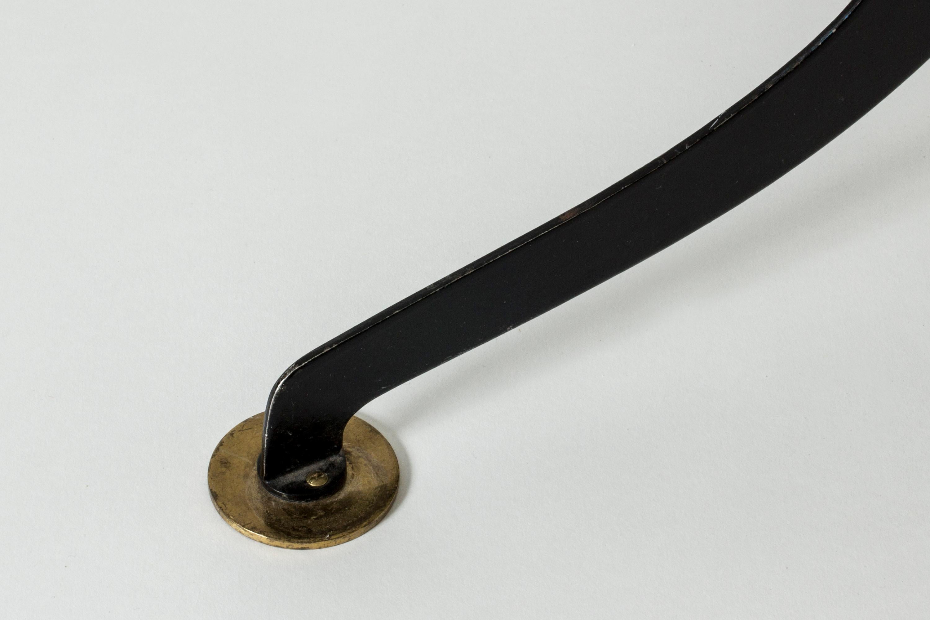 Beautiful, rare floor lamp by Josef Frank, made from black lacquered metal and brass. Distinctly sculpted base, pleated satin shade with loose brass top.

Josef Frank was an Austrian-born architect and designer known for his contributions to the