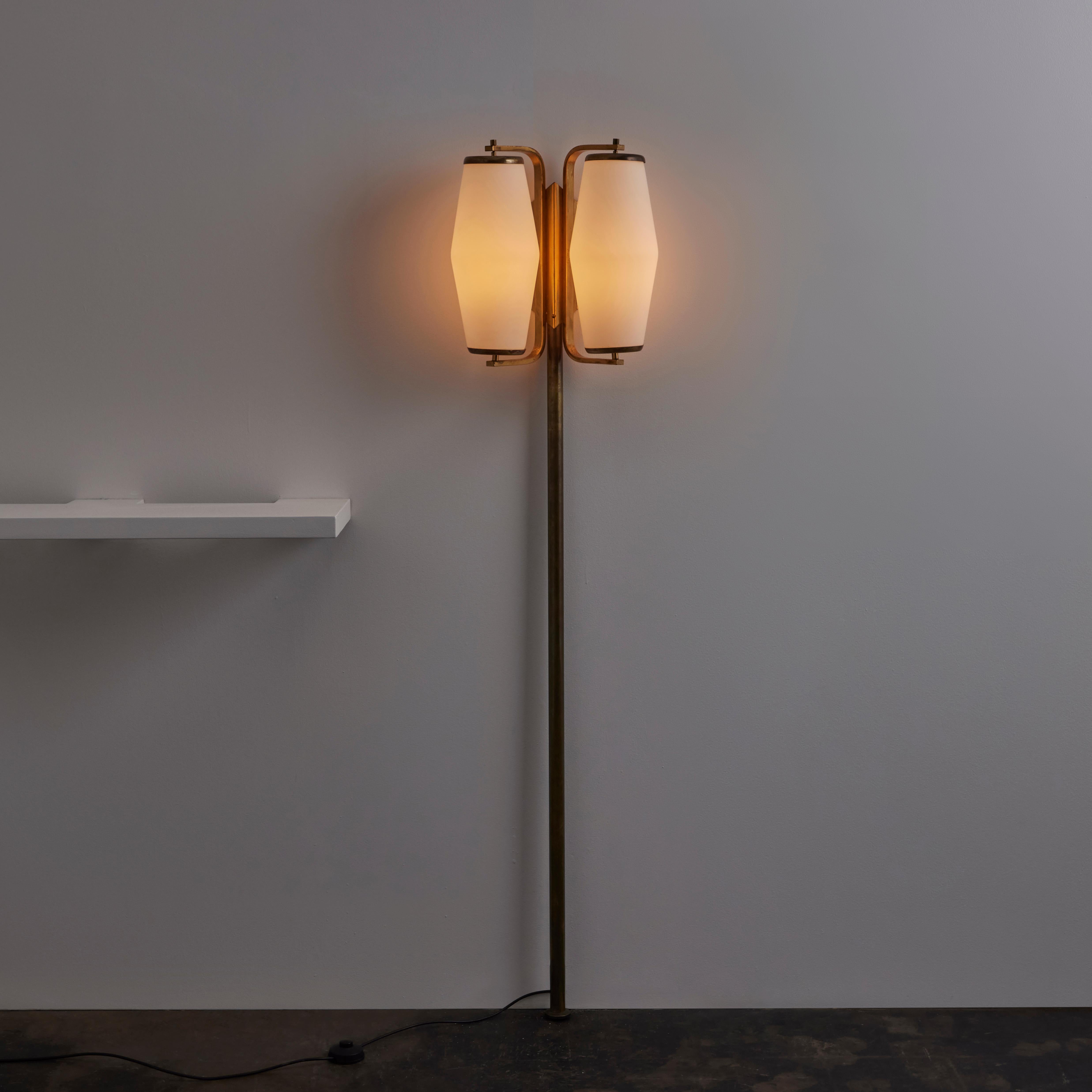 Rare Floor Lamp by Stilnovo. Designed and manufactured in Italy, circa the 1950s. A gorgeous wall-mounted floor lamp comprising of double-breasted opaline glass diffusers and a polished brass post. The wall-mounted bracket located near the top