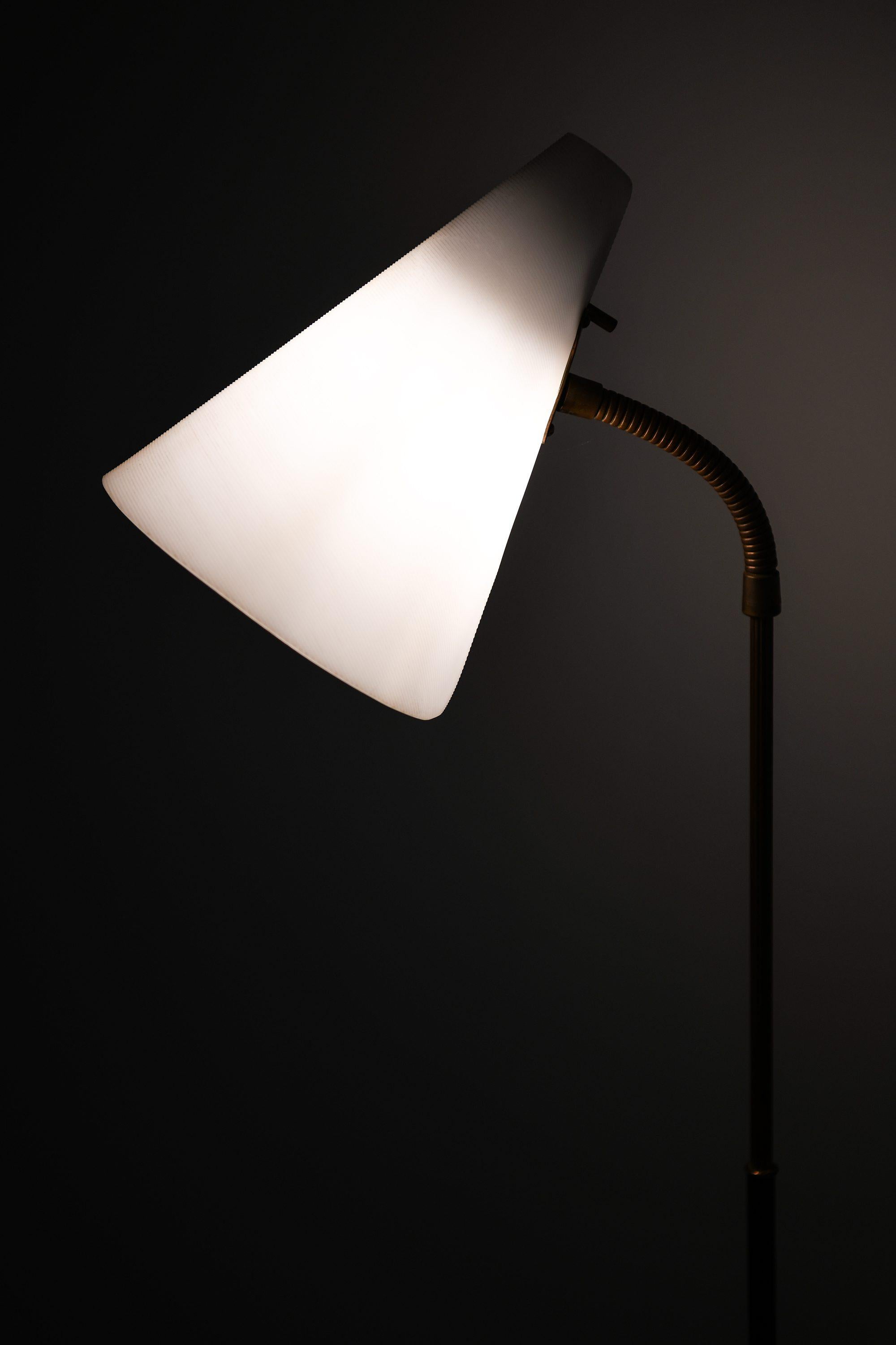Swedish Rare Floor Lamp in Black Lacquered Metal, Brass and White Plastic, 1950’s For Sale