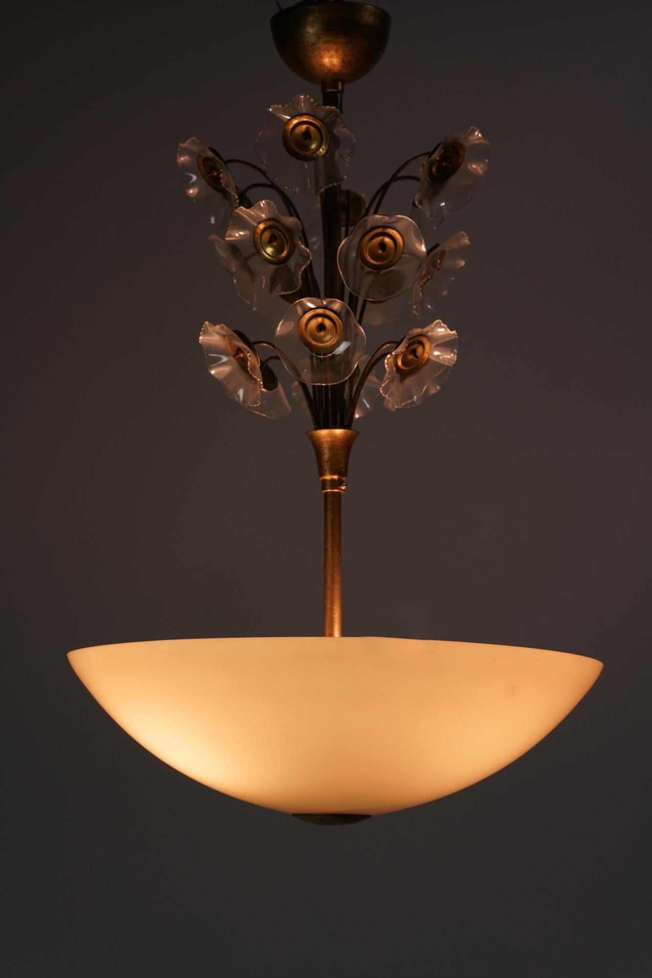 Rare floral chandelier, by Lisa Johansson-Pape from the 1940s. Glass and brass. Beautiful intricate flower details. Good vintage condition, minor patina consistent with age and use. Classic Lisa Johansson-pape design suitable for many spaces. 

Lisa