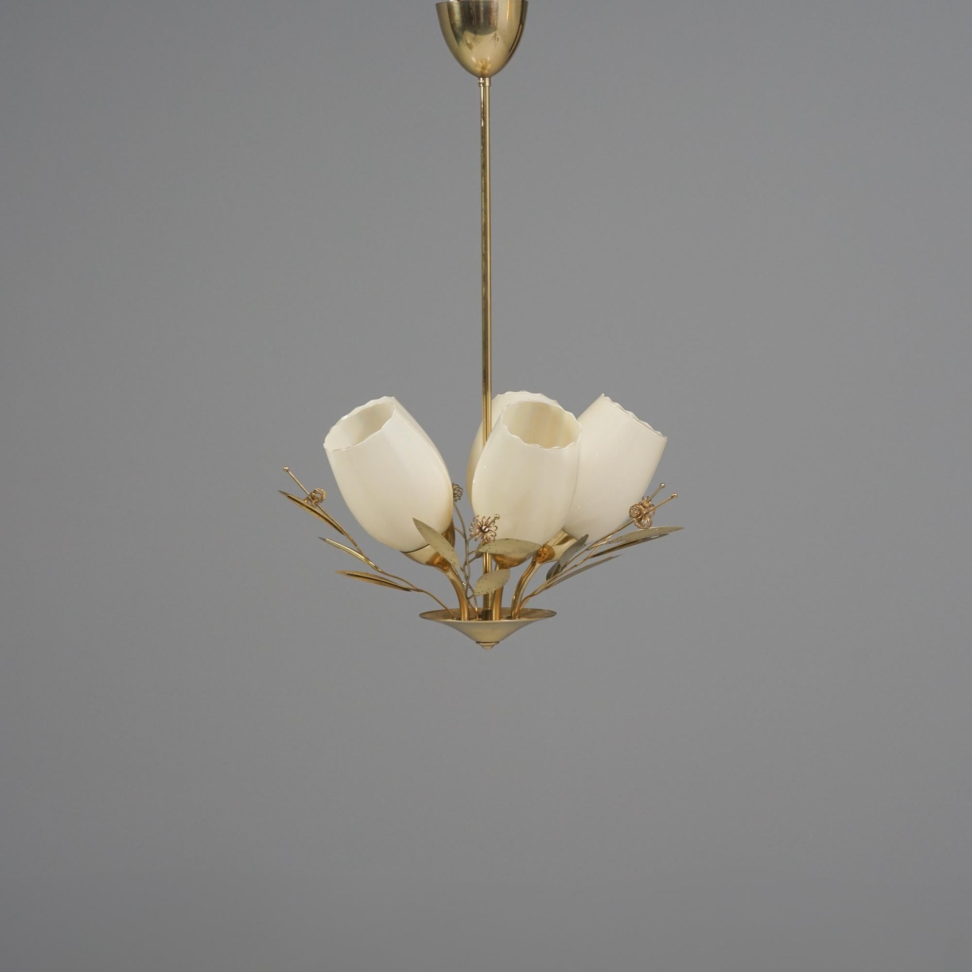 Raro colgante, fabricado por Itsu, años 50. Marco y detalles de latón, tulipas de cristal opalino. Detalles florales de estilo similar al ramo de novia de Paavo Tynell. Marca del fabricante. Buen estado vintage, pátina menor acorde con la edad y el