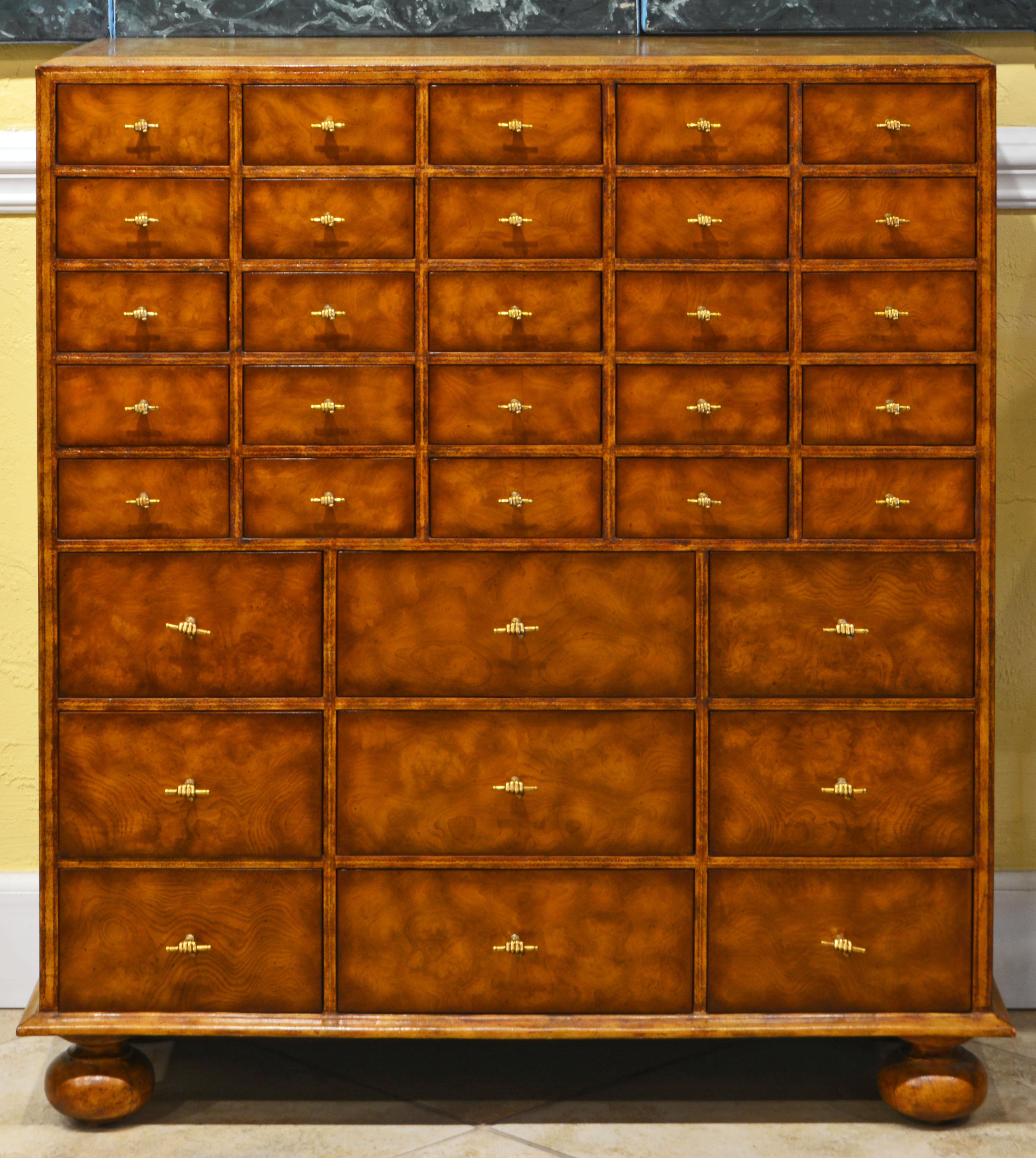 A rare mid-century Maitland-Smith Florentine style chest of 34 smaller (upper part) and larger (lower part) drawers. The sides and top are entirely clad in finely tooled and gold trimmed light tanned leather. The drawer fronts feature a warm honey