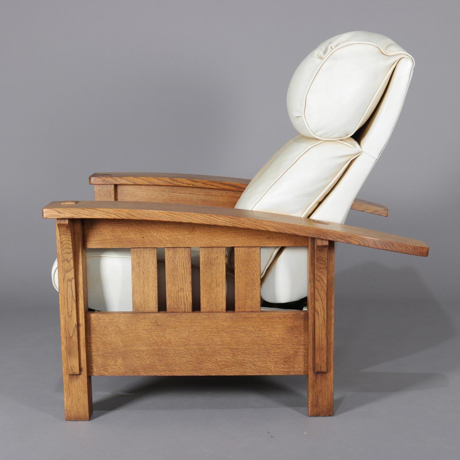 Rare form Arts & Crafts Stickley Bros. Morris chair features oak frame with bow arms over slat form sides reclining to include footrest, overstuffed and leather upholstered, brand and label on inner back leg, circa 1980.

Measures: 37.5