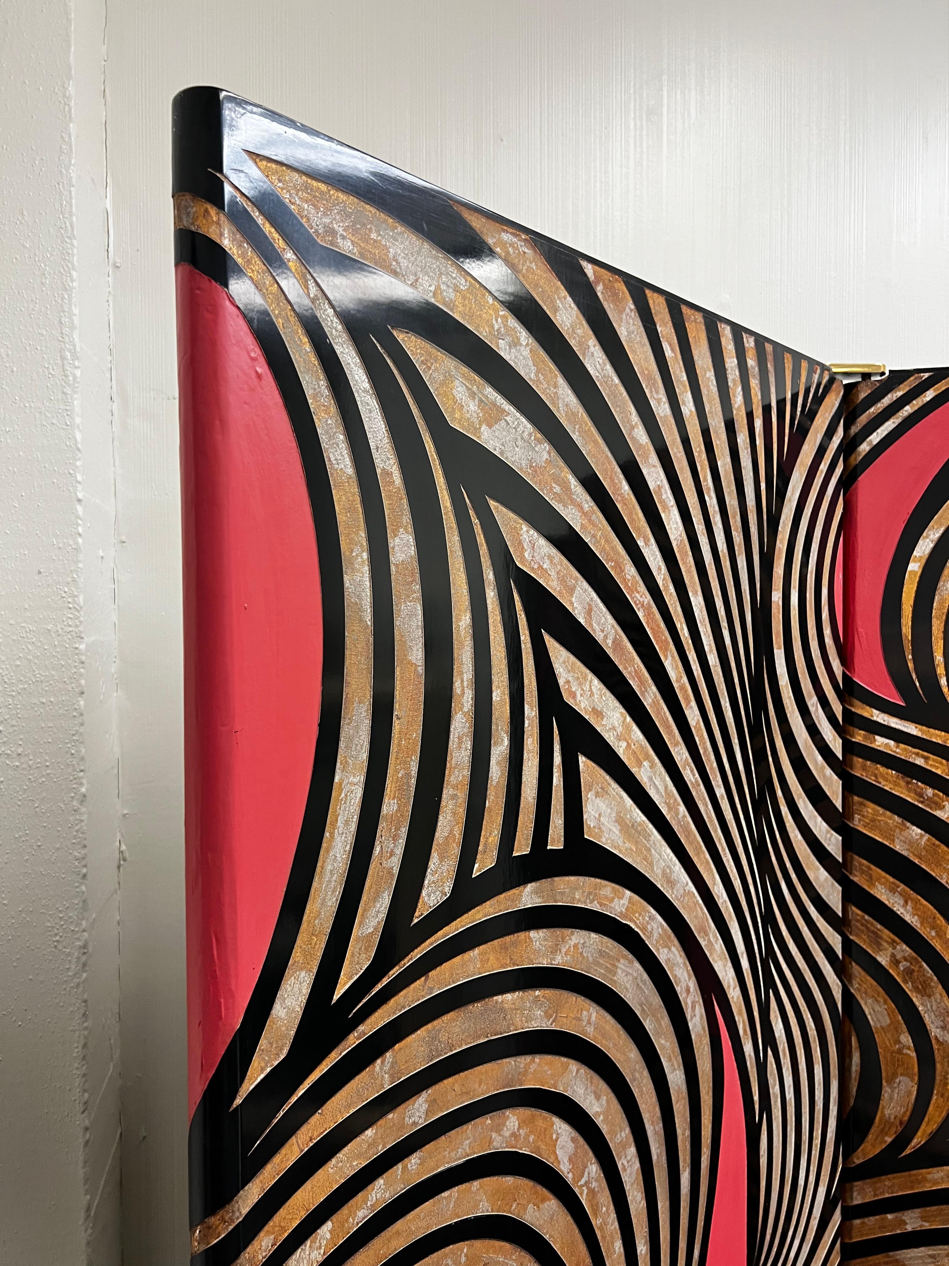 An Incredible 1970 rare four panel “Coromandel” Screen by Karl Springer. 
The front design is hand carved and painted with black and coral lacquer with antiqued gold and silver leaf detailing. 
The panels are joined together with polished bronze
