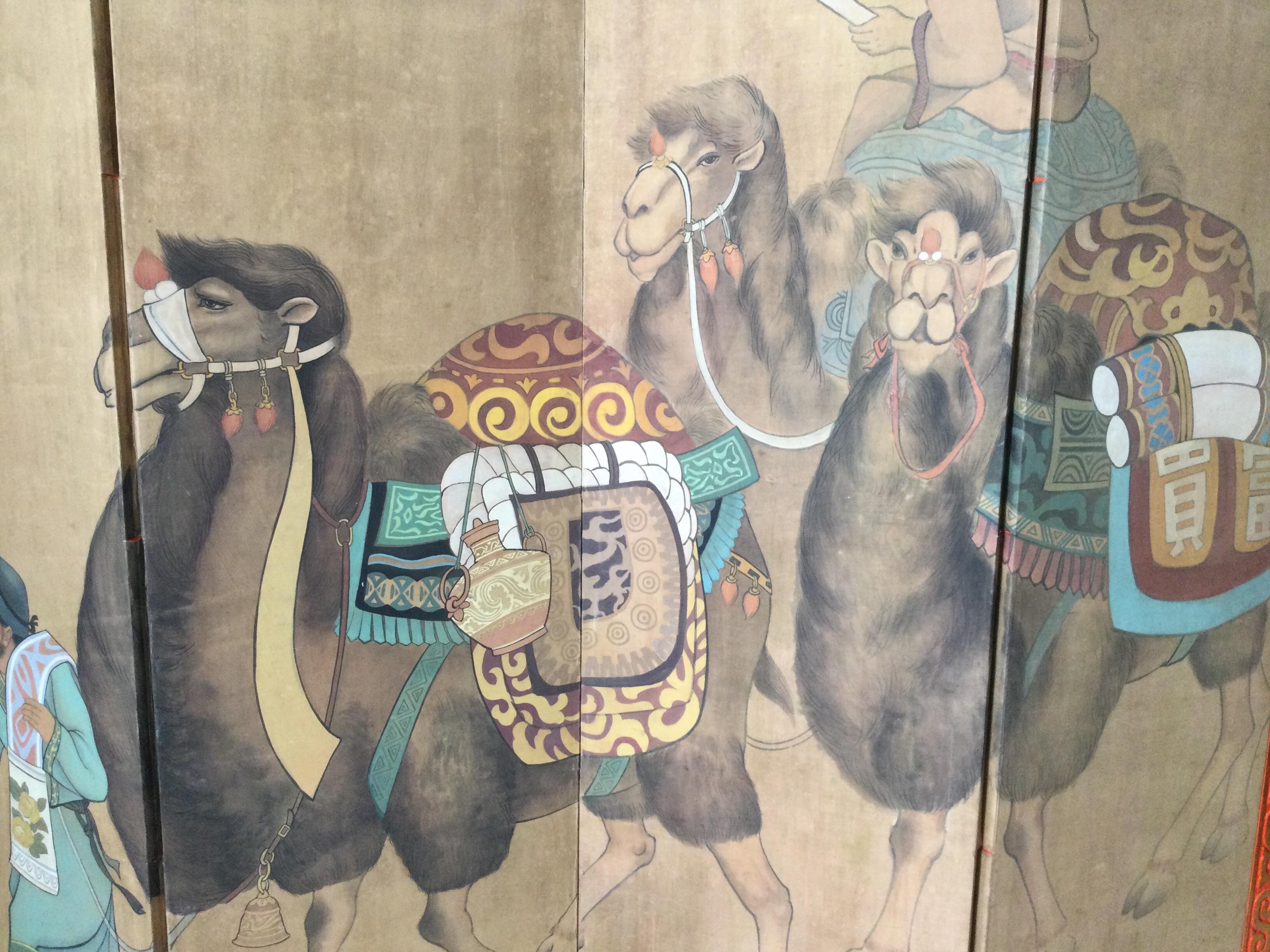 Rare 4 panel hand painted screen on canvas featuring three Bactrian camels lead by a Mongolian Sherpa with dog. Good consistent condition with its age (100 years) no tears to canvas, some paint chipping to frame.