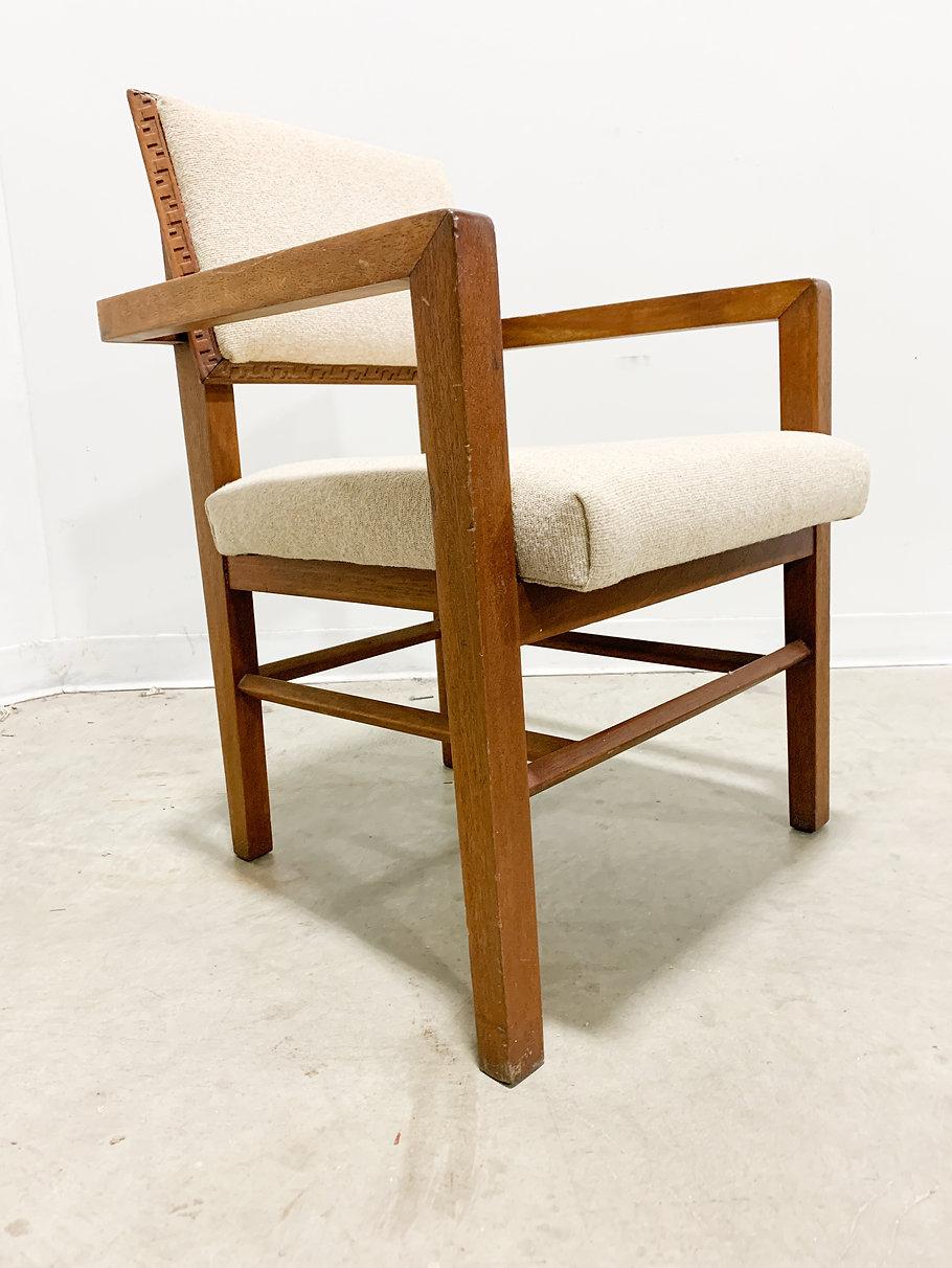 Rare armchair from the Taliesin line of furniture designed by Frank Lloyd Wright and his apprentices and made by Heritage-Henredon. Featuring Wrights's signature architectural forms and edge details, this chair makes its presence known. It is also
