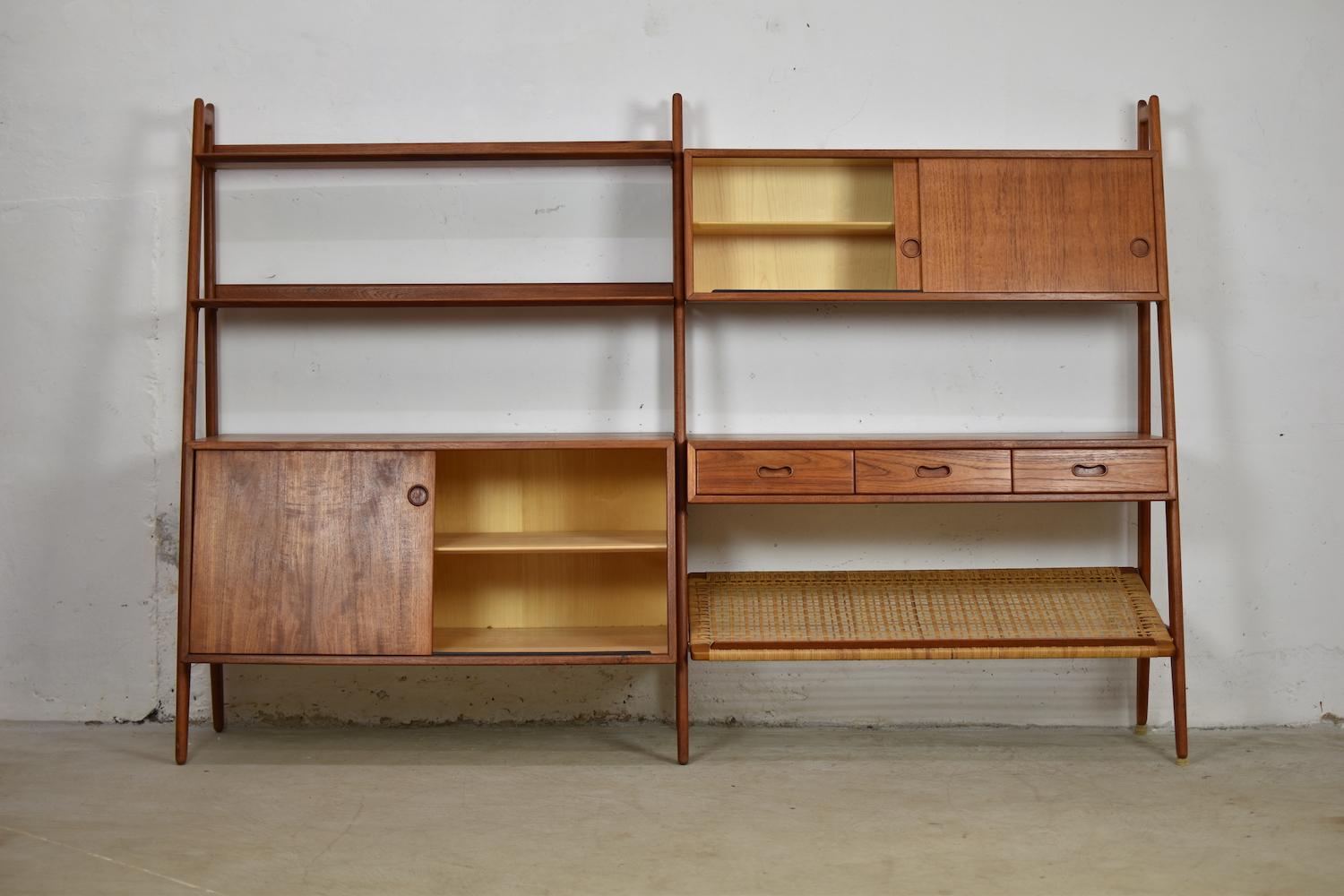 Proud to present you this rare freestanding bookshelf designed by Arne Vodder & Anton Borg for Vamo, Denmark, 1950s. This bookcase features several shelves, cabinets and a rattan magazine holder, all in teak. Freestanding because of the finished