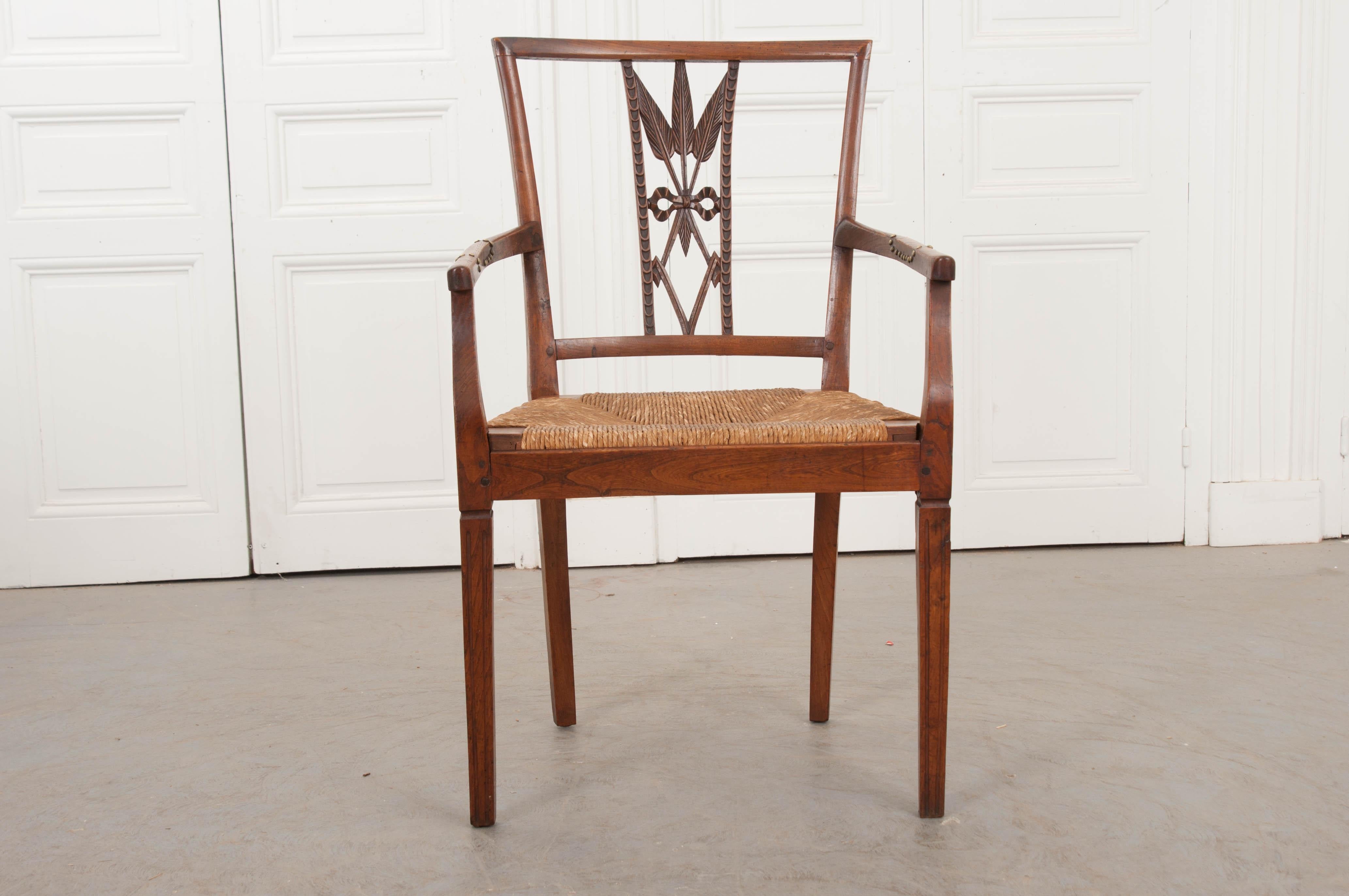 This remarkable and rare Louis XVI-style oak armchair, circa 1850, is from the provincial countryside of France and features a unique “wheat-sheaves-and-diamond” chair back design over a fantastic removable rush seats and supported on delicate