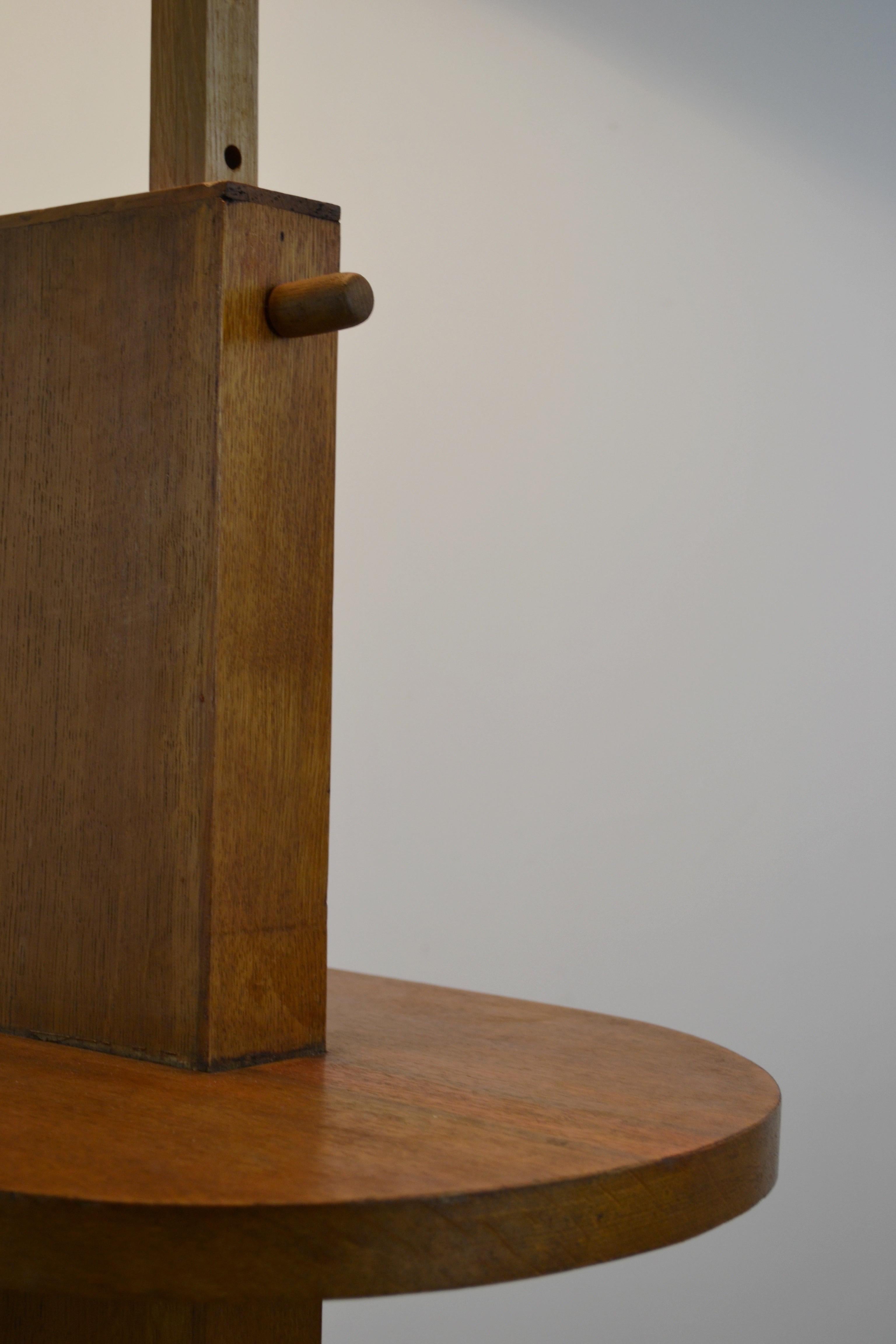 The architectural oak and oak veneer structure features two refined half-moon shelves, combining practicality with sculptural presence.
Its adjustable height on seven positions demonstrates both ingenuity and timeless functionality.

Recently