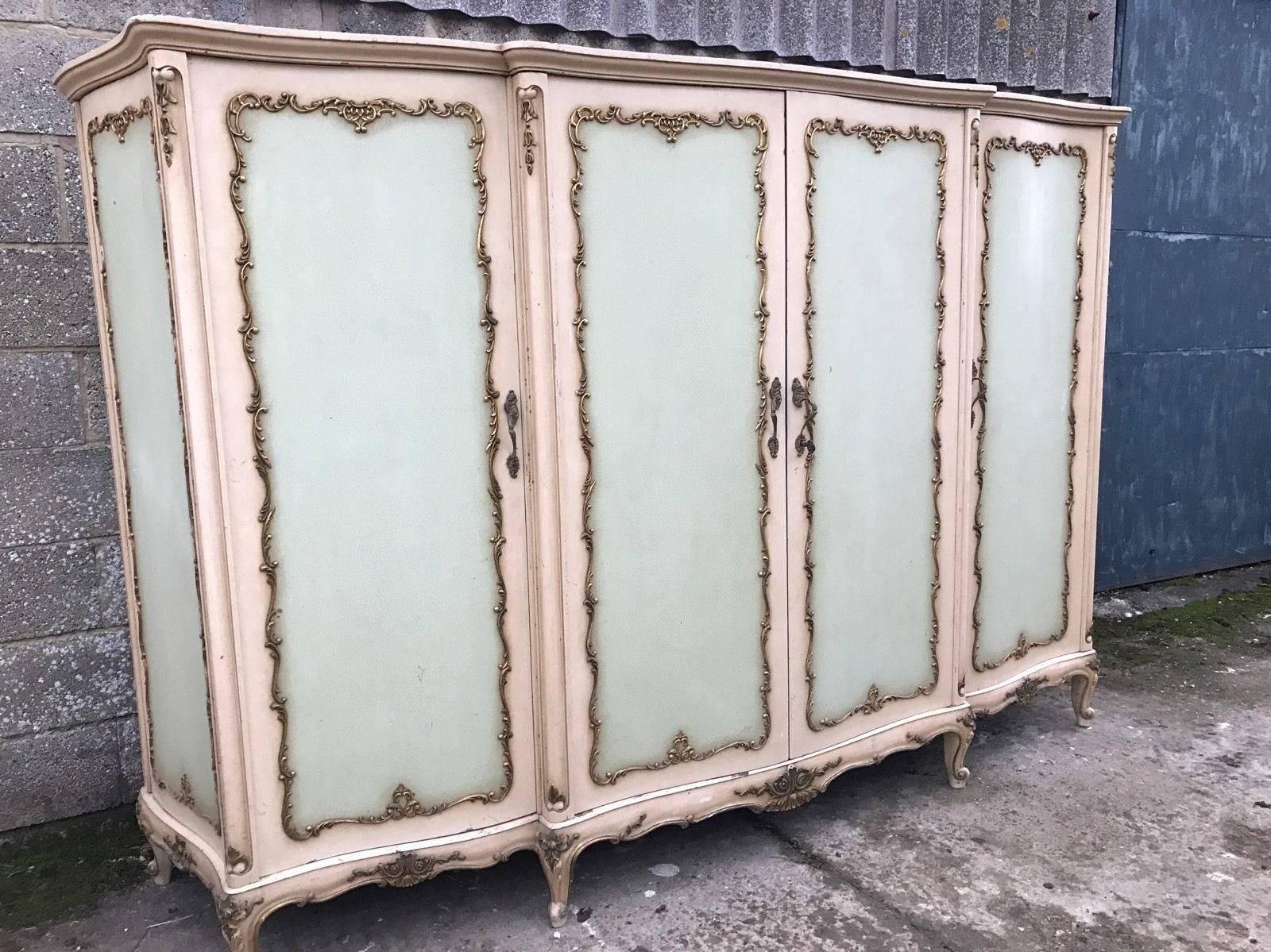 This is a very rare four-door, serpentine French armoire. Very hard to come by, rarely seen for sale anywhere in the world! 

With its original paint and original floral paint work, it really is a one off. 

Dimensions: 275cm wide, 182cm tall,