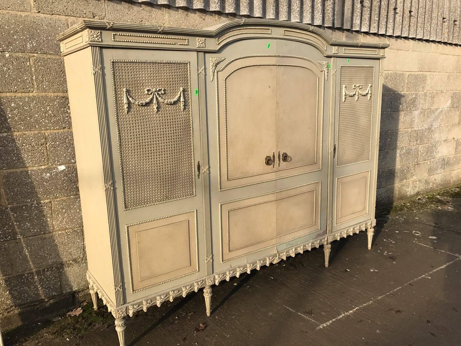 This is a very rare four-door French armoire. Very hard to come by, rarely seen for sale anywhere in the world!

With its original paint and original floral paint work, it really is a one off. Also, original rattan work.

Splits down in to