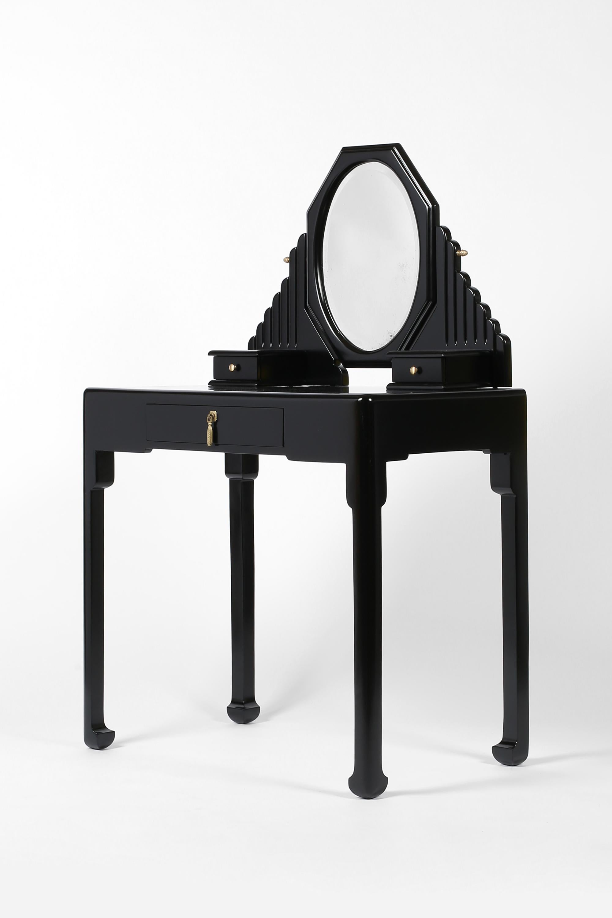 A rare Art Deco carved timber dressing table attributed to Paul Poiret for Atelier Martine. Featuring an octagonal swing mirror with original bevelled plate, a shaped stand with two small table top drawers, single front drawer with decorative bronze