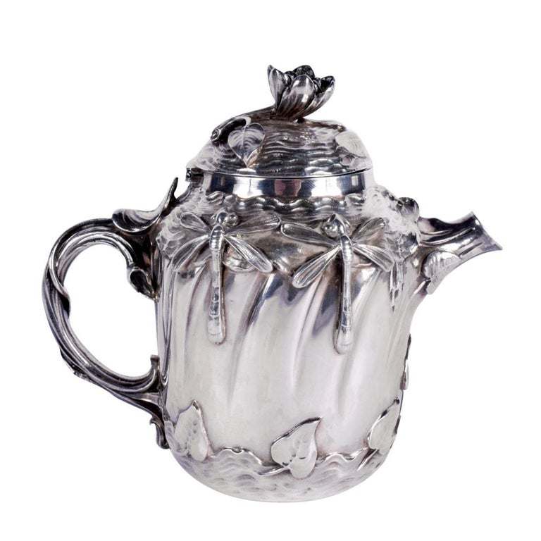 Sterling silver teapot decorated with Art nouveau patterns in relief, such as flowers, leaves, and dragonflies. 
At the end of the 19th century, many artists have been inspired by the profusion of flora and fauna under the influence of Japonism and