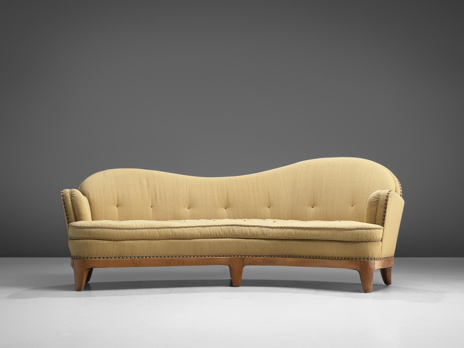 Curved sofa with stained beech frame and beige fabric, France, 1930s.

Extra-ordinary sofa of which we cannot identify its origin after long research. We expect it to be French or Swedish, based on the aesthetic features and materialization. The