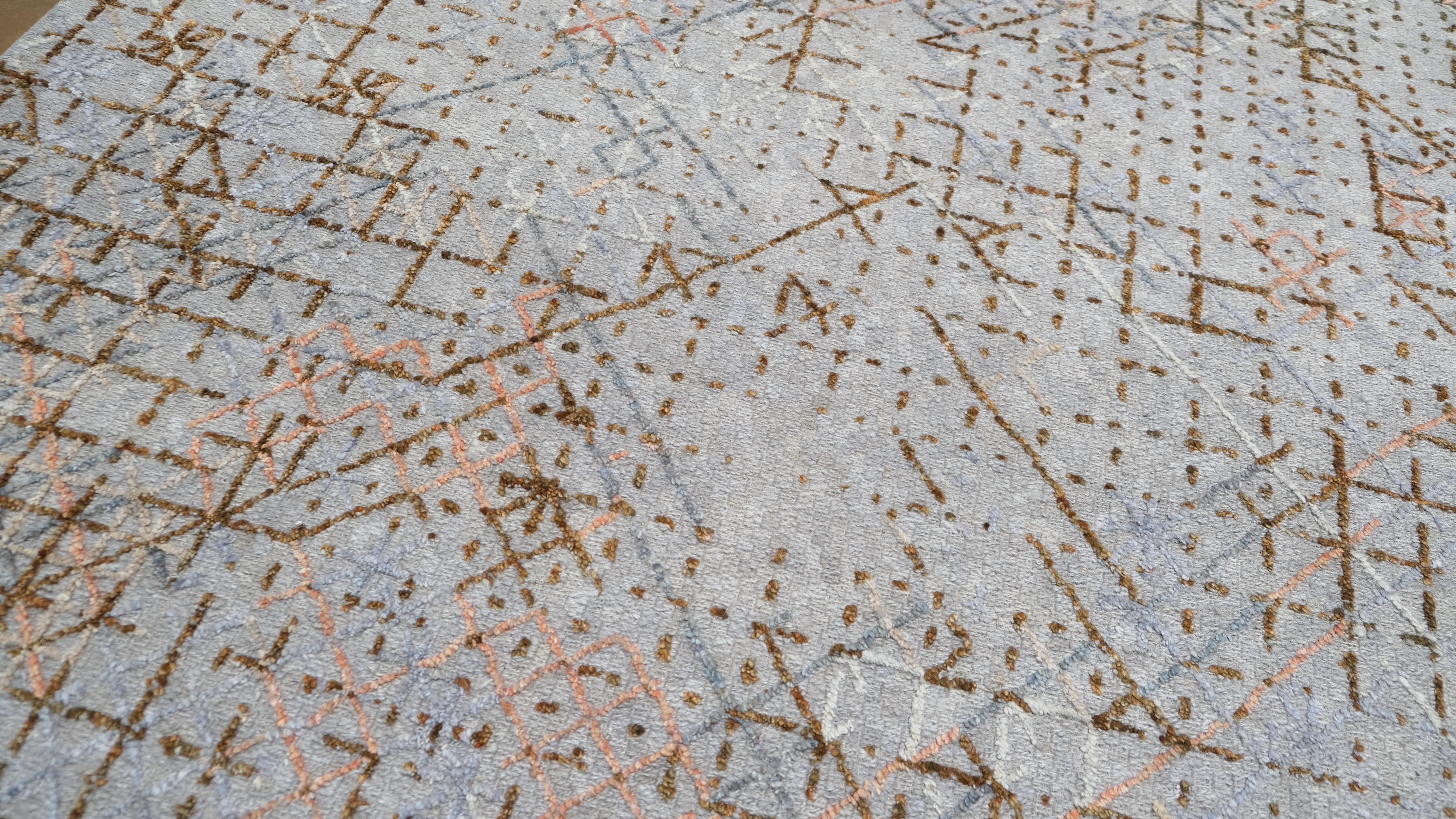 Featuring a complex abstract geometric pattern in a sophisticated palette of soft neutrals with subtle hints of pink and gold. This unique design adds depth and intrigue to modern and contemporary interiors, making it a stunning centrepiece for any