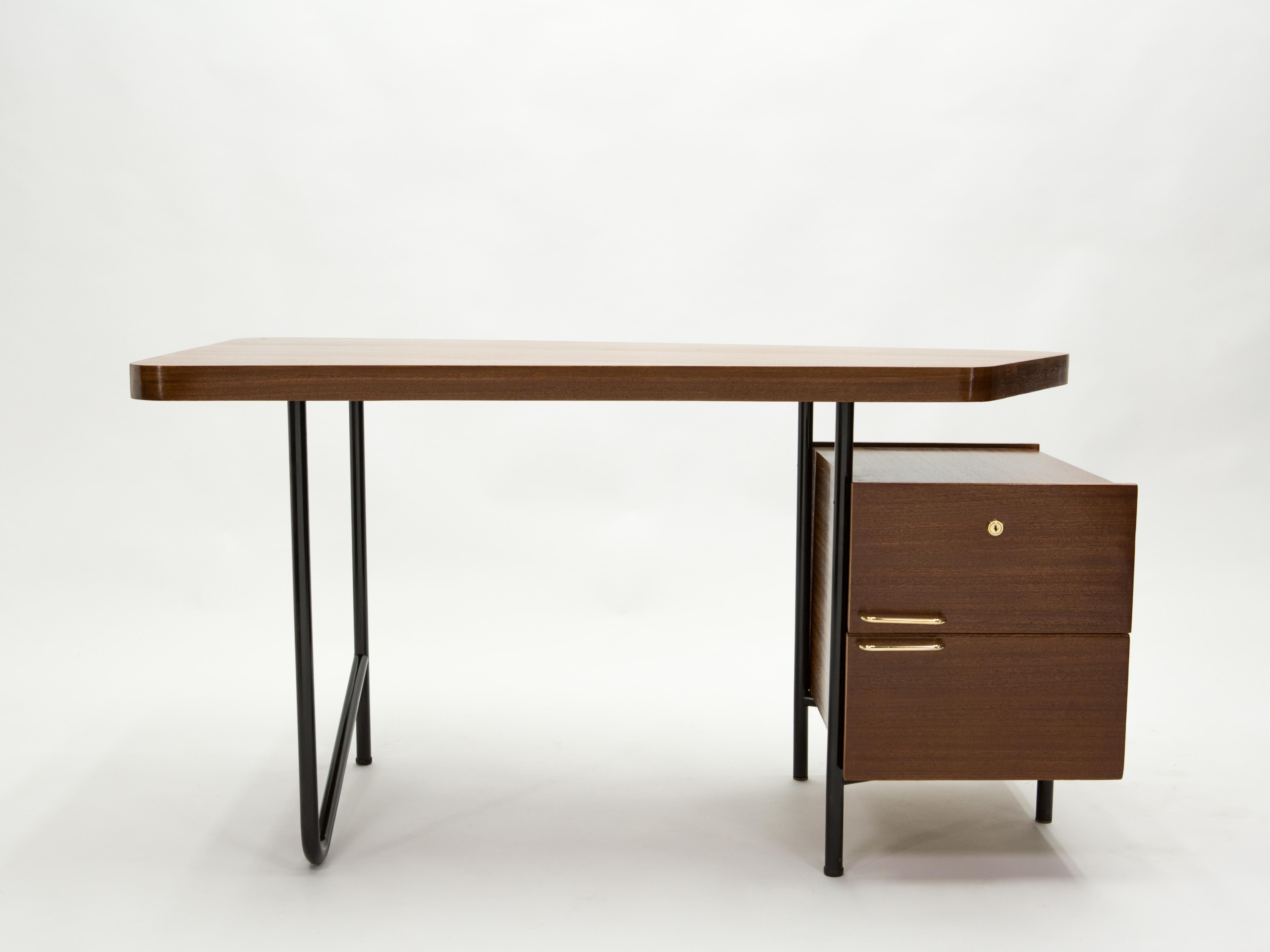 This rare and beautiful French modernist desk was made by Georges Frydman for EFA editor in the late 1950s. It features a fully mahogany veneer on the asymmetrical top and two drawers with brass handles and lock, with black painted tubular metal