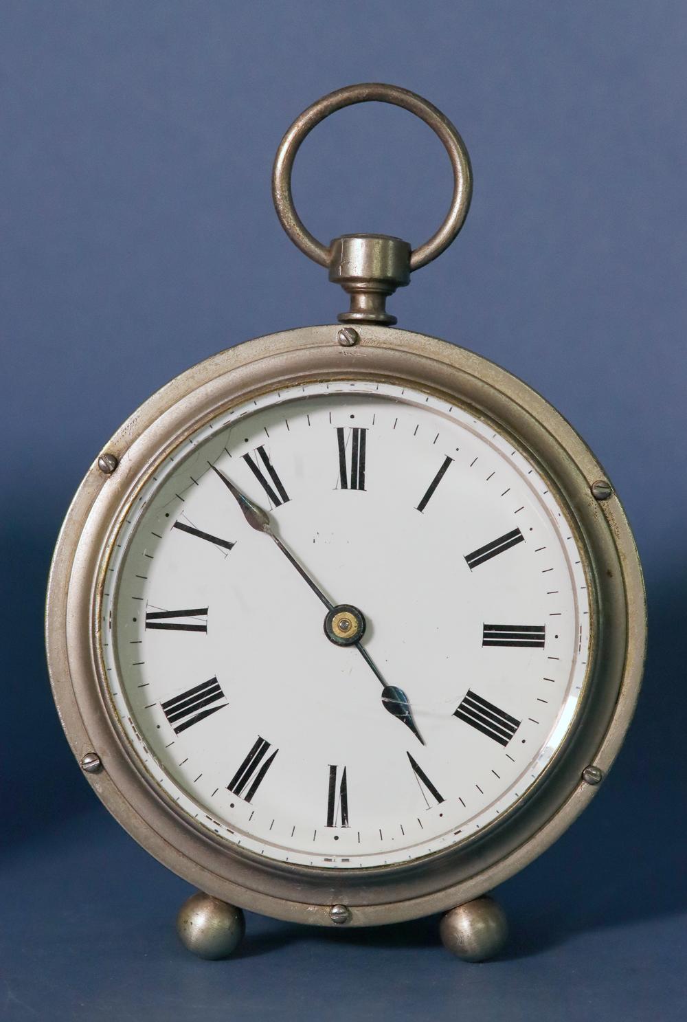 Rare French Drum Carriage Clock with Unusual Escapement. F333

RED, No.25.

The nickel drum shaped case has shaped posts screwed to the front and back, a shuttered back, a glass tube that protects the movement, a ring to the top and small ball