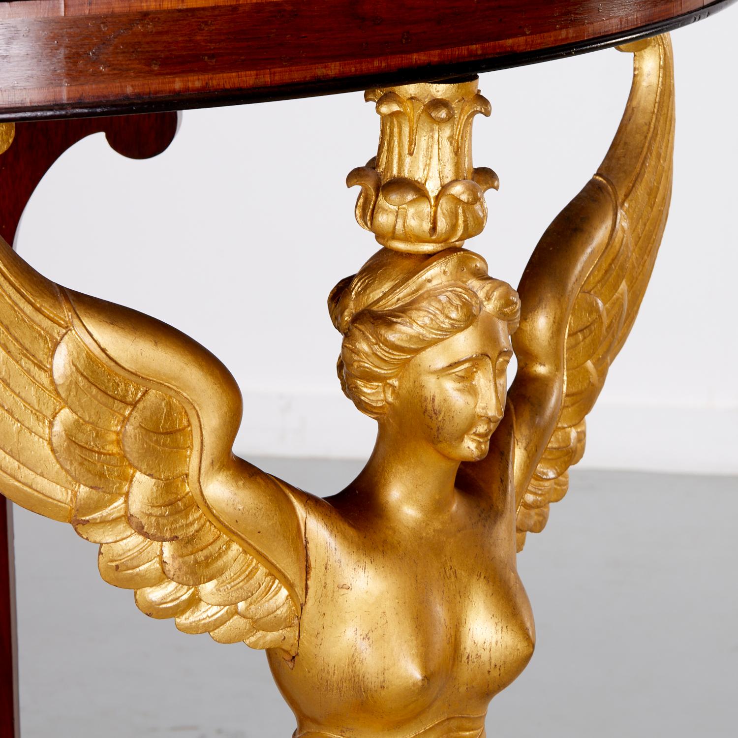 A Fine and Rare French Empire Mahogany Corner Console or 'Encoignure', late 19th cent. with  a triangular top of ebonized molded edge, raised on a finely sculpted giltwood winged caryatid.

Highly decorative, superb quality and craftmanship : a rare