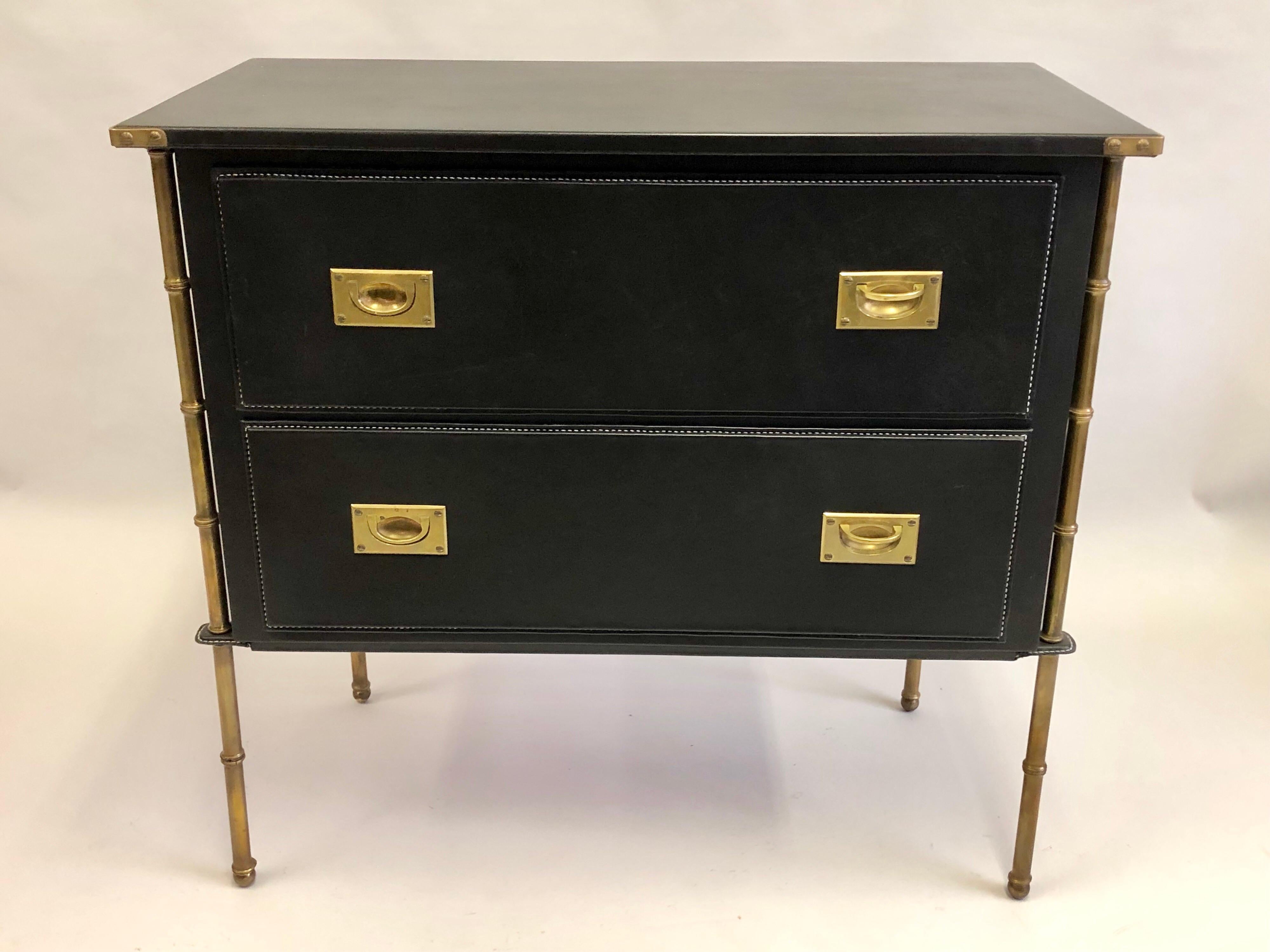 A Rare French Midcentury Modern hand stitched leather cabinet, dresser, commode, chest of drawers by Jacques Adnet, circa 1955. The entire composition is subtly balanced with muted black leather and burnished brass coloration. The piece features