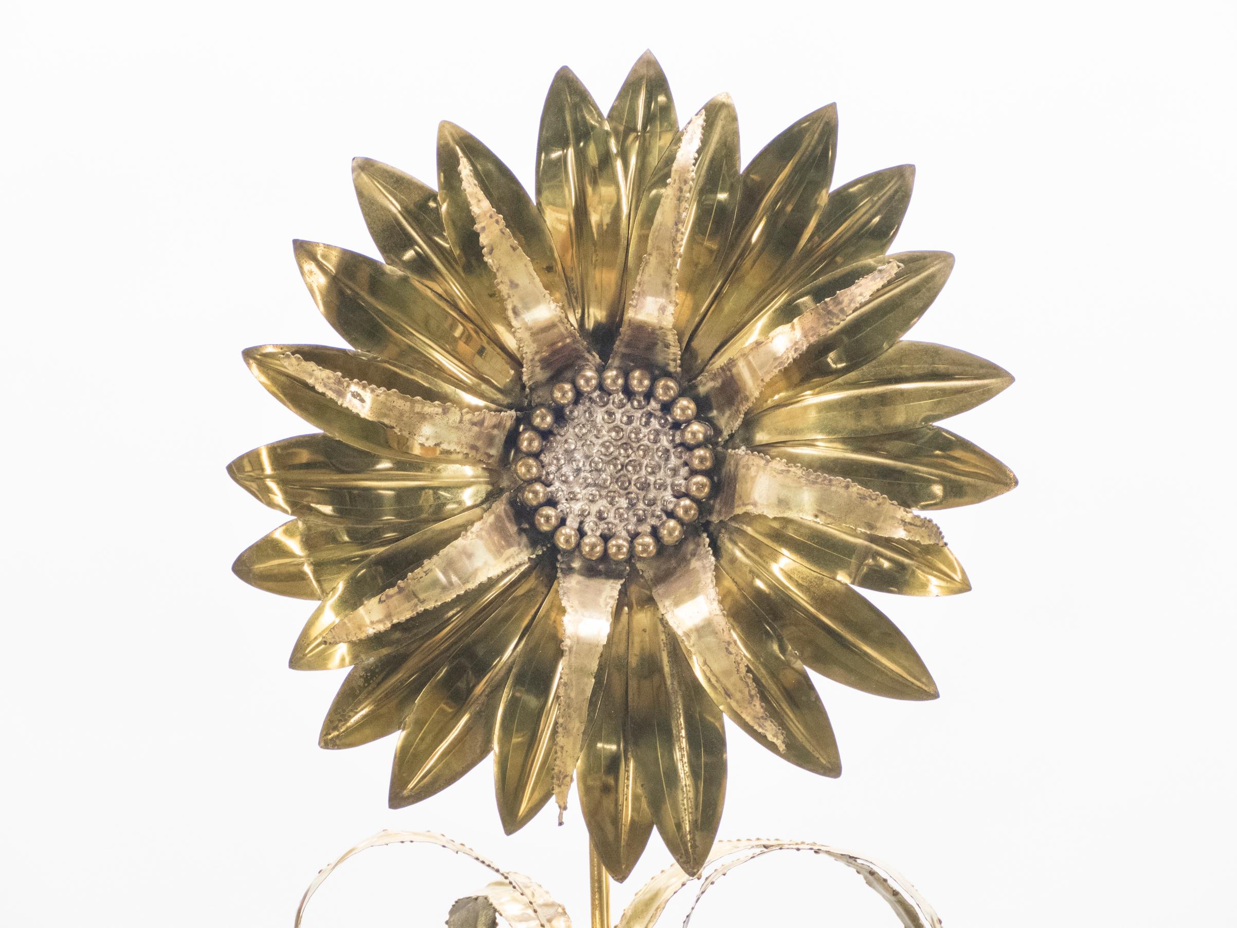 In this table lamp, an oversized, bold sunflower made of brass is lit up from behind by four separate bulbs, casting cheerful, glowy reflections throughout your space. The lamp was made by renowned French design firm Maison Jansen during the 1970s