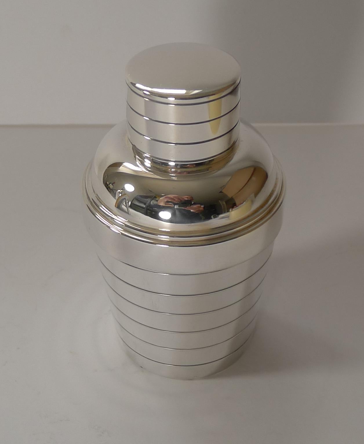 A fabulous and scarce little French individual cocktail shaker made in silver plate. The top section once removed, reveals an integral lemon squeezer or reamer which can sit upside down on the base and the juice of lemons or limes squeezed directly