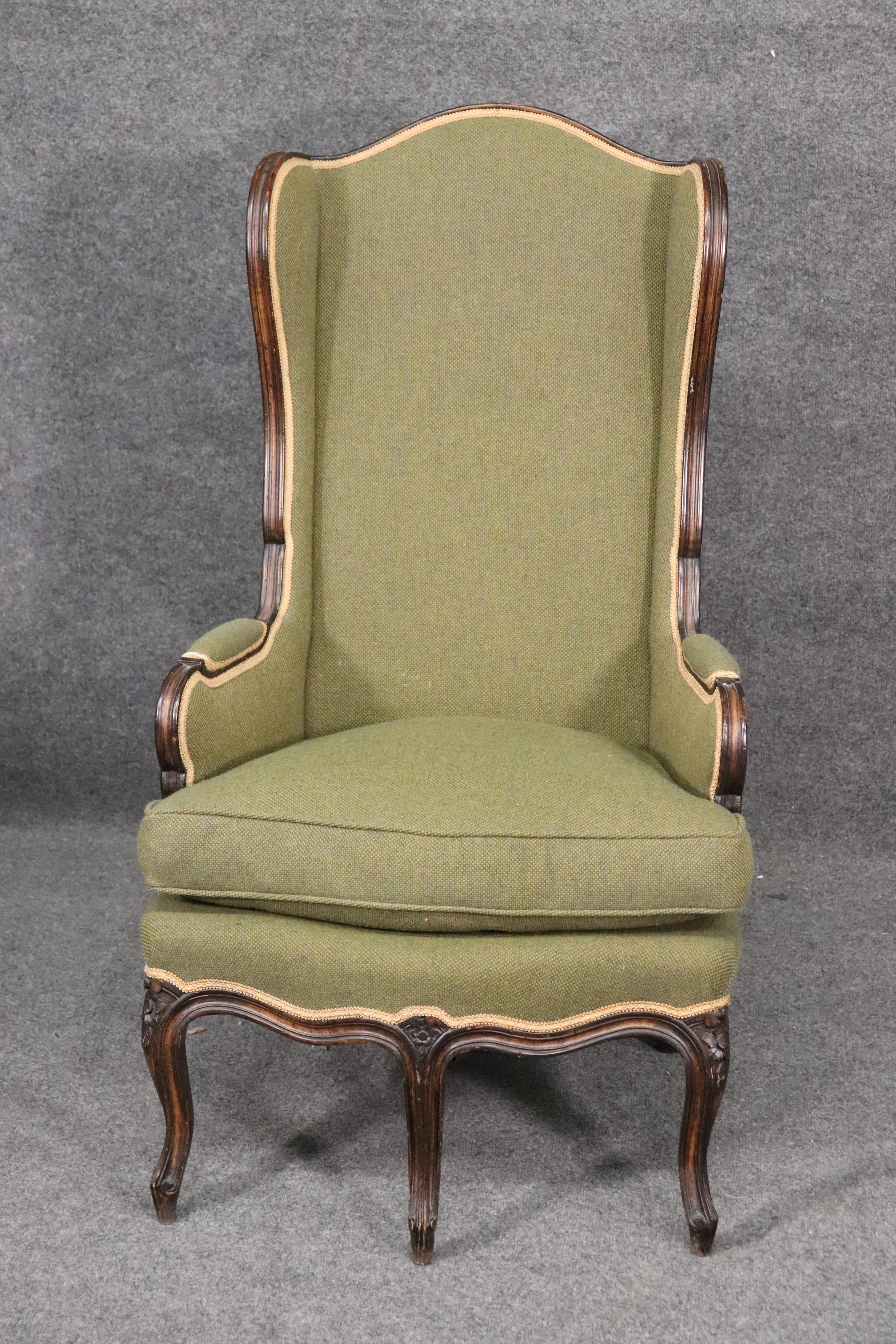 This is a very rare form of French chair. The chair has 5 legs with 3 in the front and this is an unusual thing to find. The chair is upholstered in what I believe is an Oliver green wool tweed upholstery and the frame is in good condition.