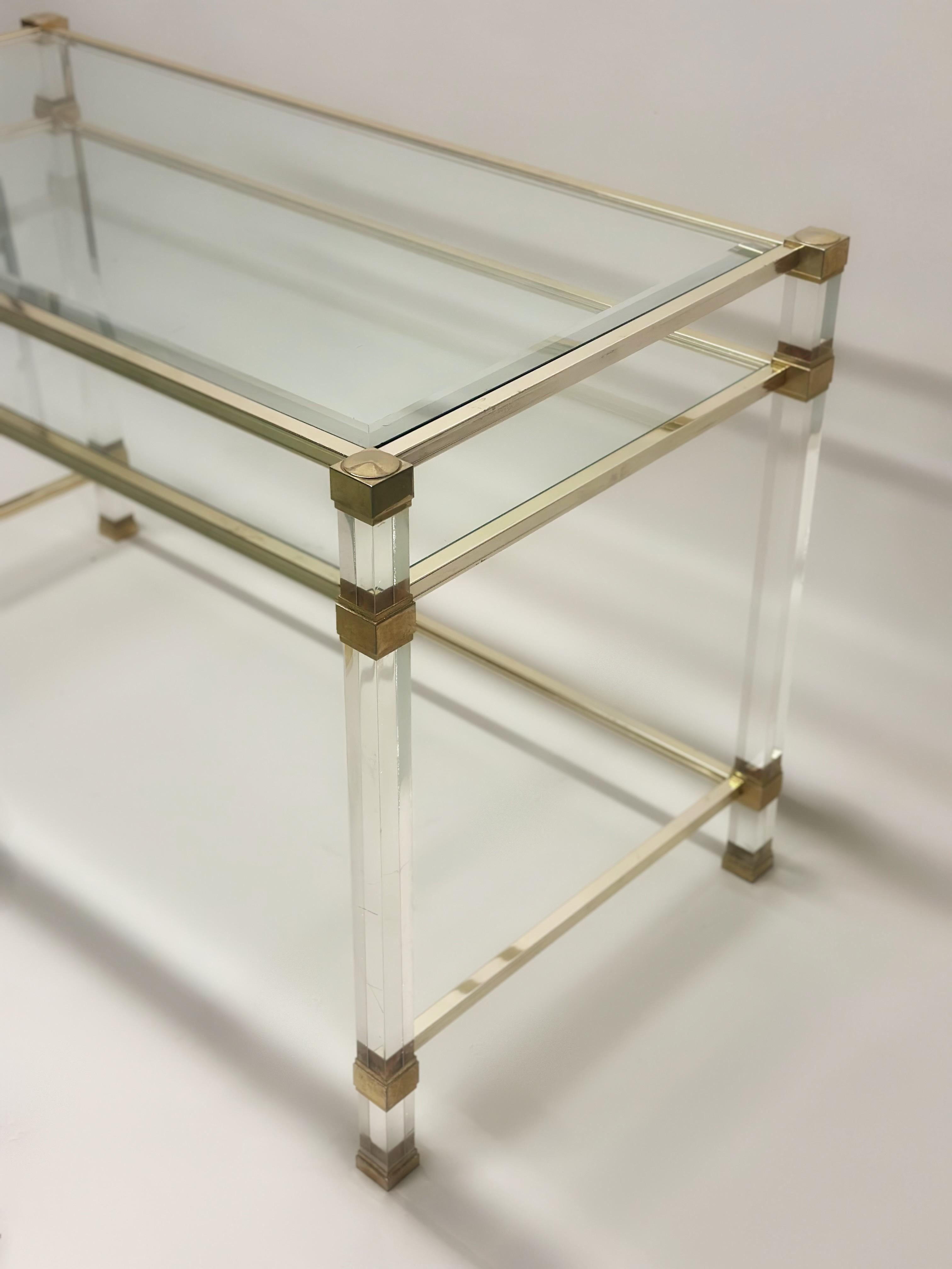 Elegant French Mid-Century Modern lucite and glass desk /writing table / vanity by Pierre Vandel. This piece expresses the essence of modernism. It's transparent, minimal and functional. The elegant frame is in nickeled brass and the transparent