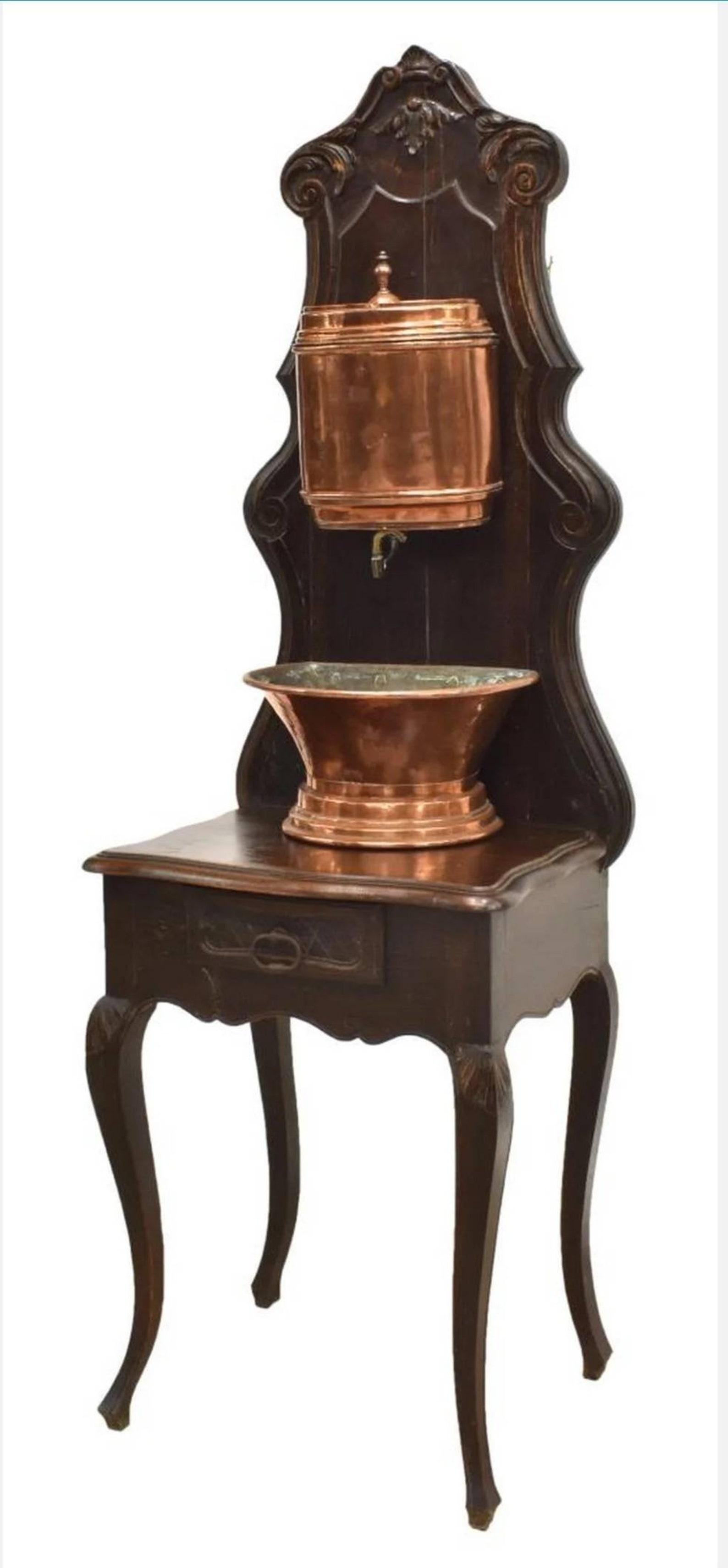 A wonderful and rare, almost 200 year old antique French Provincial Lavabo (water fountain) with beautifully aged patina. Handcrafted in Louis XV taste, dating to around the second quarter of the 19th century, having a hand carved oak stand with