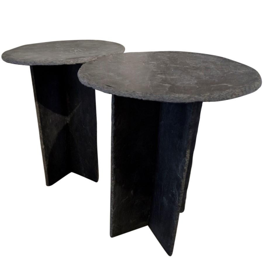 Each table hand assembles from three pieces of slate, two rectangular shaped interlocking pieces as a stand and a circular top. Available individually or as a pair.