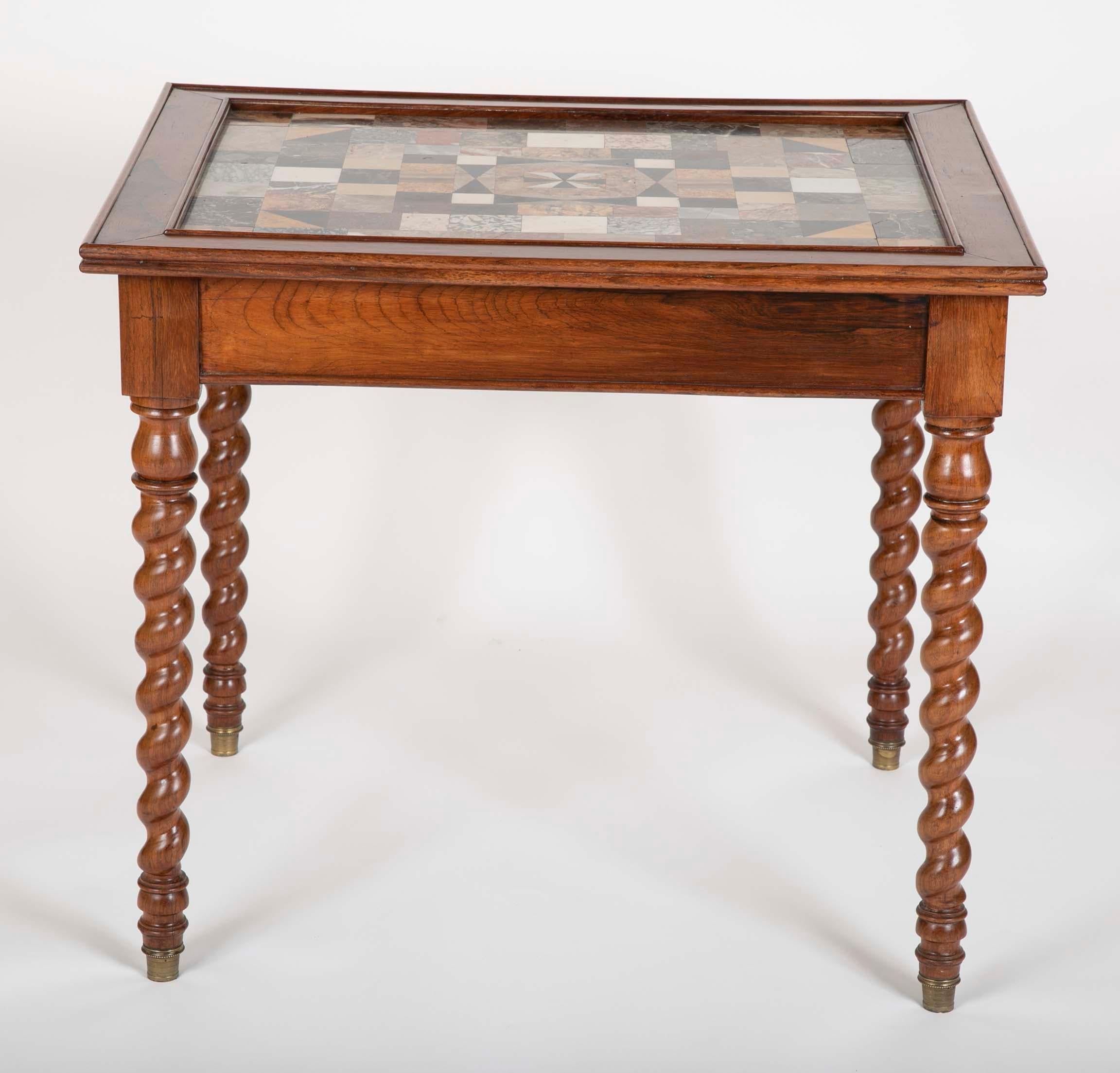 A rare French table having a thick specimen marble top inset sitting on four barley twist legs.