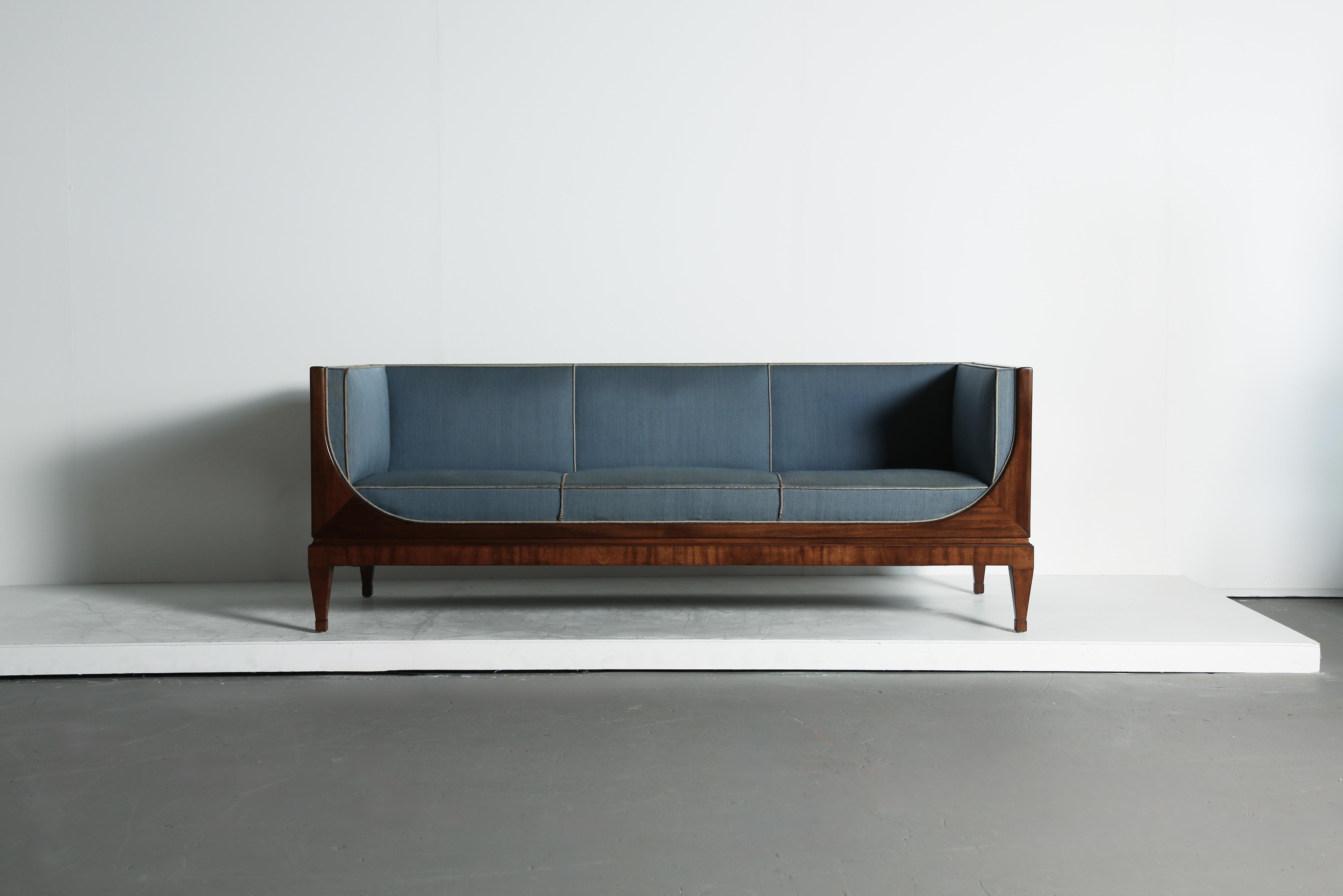 Rare Frits Henningsen box sofa, Denmark, 1940s-1950s. Designed and produced by Frits Henningsen, Copenhagen.  Wooden frame and presumably original blue fabric and contrast piping.  Wood frame in good vintage condition with minor signs of use and