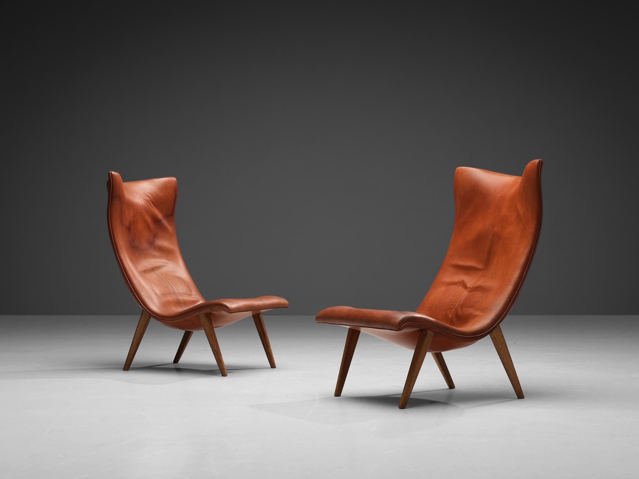 Frits Henningsen, lounge chairs, oak, original leather, Denmark, 1950s

These two most rare lounge chairs by Danish designer and cabinetmaker Frits Henningsen feature highly elegant, organic lines. A stunning combination of round forms and clear
