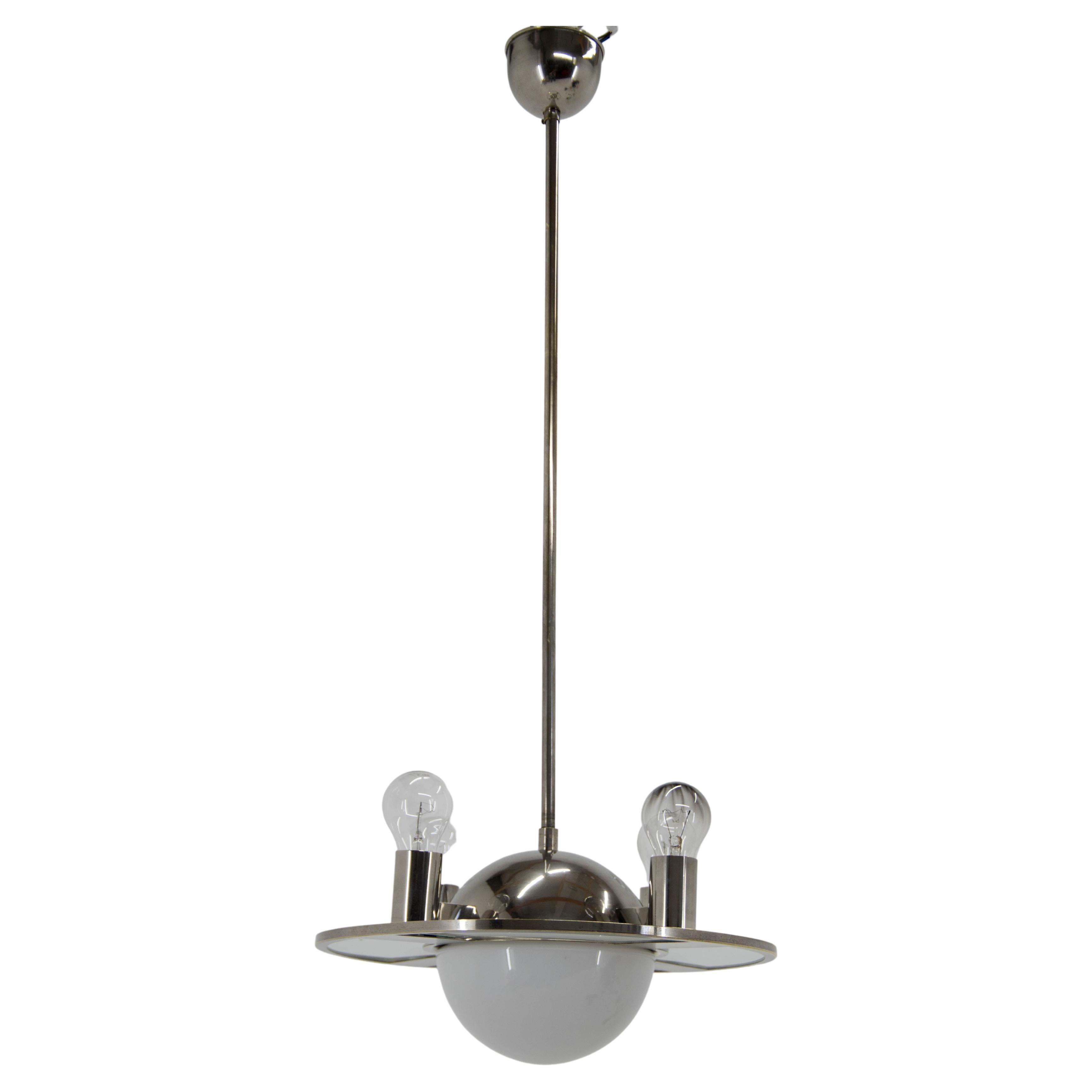 Unique Bauhaus or Functionalist chandelier from 1920s made of nickel, sand blasted glass and opaline glass. A rare and eye-catching piece!
Restored, polished, rewired - two separate circuits 3+1x40W, E25-E27 bulbs.
Central rod can be shortened on