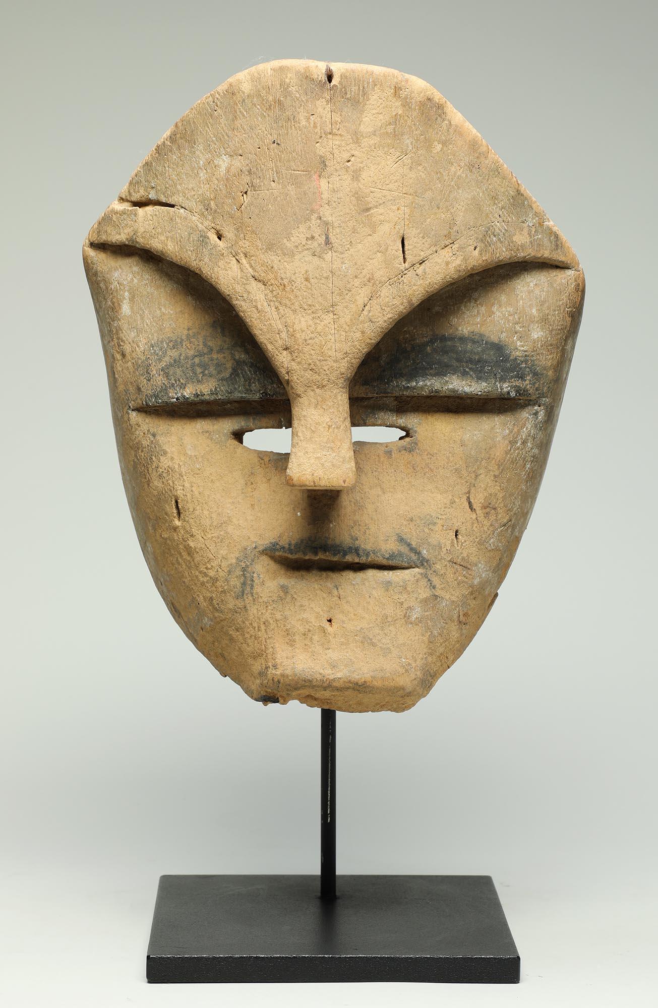 Early and rare mask from Gabon, Central Africa, created by the Tsogho peoples.  Powerful large mask with carved open eyes, and black painted eyes above, below heavy carved eyebrows.  Front of mask with weathered eroded surface, back and inside of