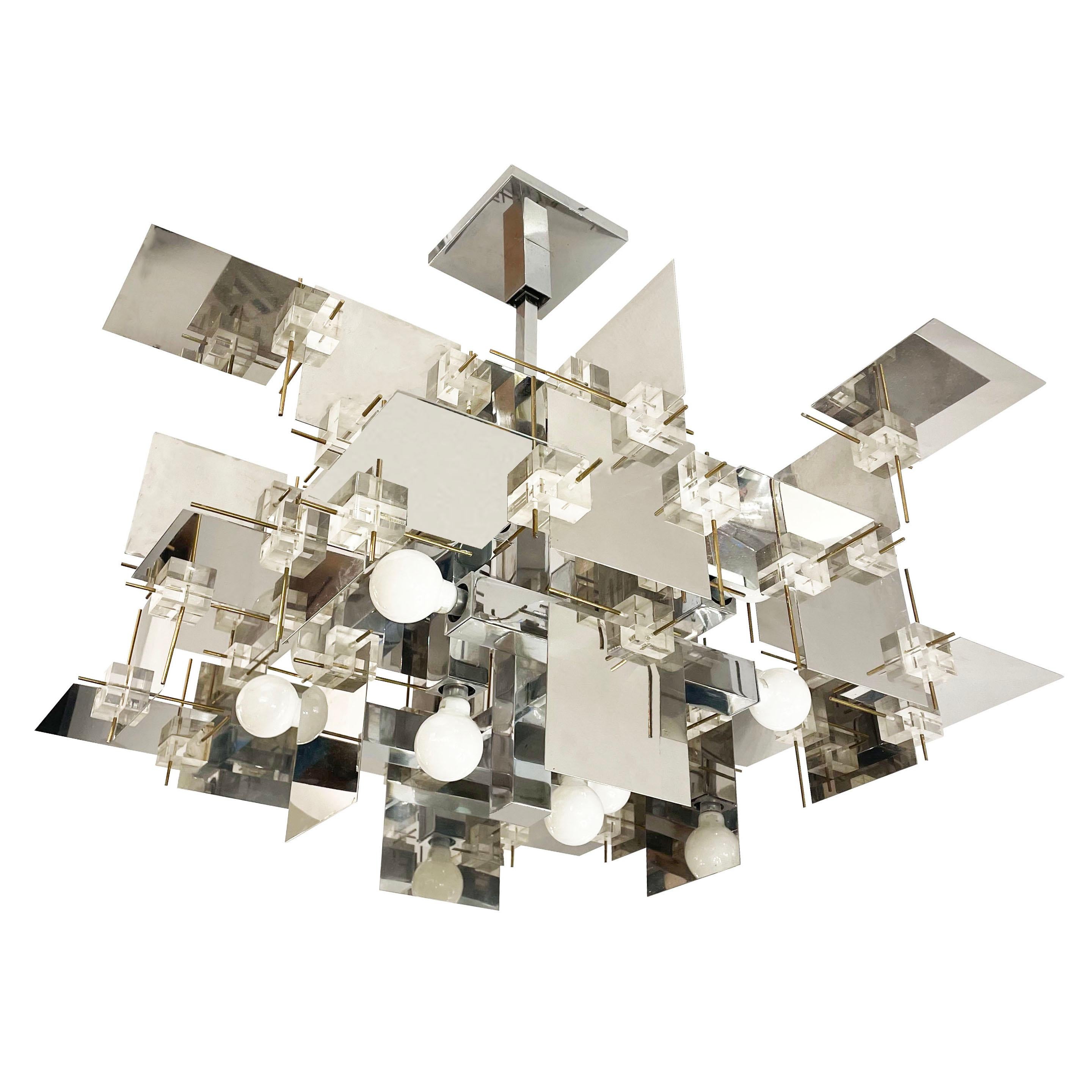 Rare and extremely coveted Gaetano Sciolari chandelier composed of intersecting chrome panels joined by lucite cubes and brass pins.

Condition: Excellent vintage condition, minor wear consistent with age and use 

Measures: Width: 30”

Depth: