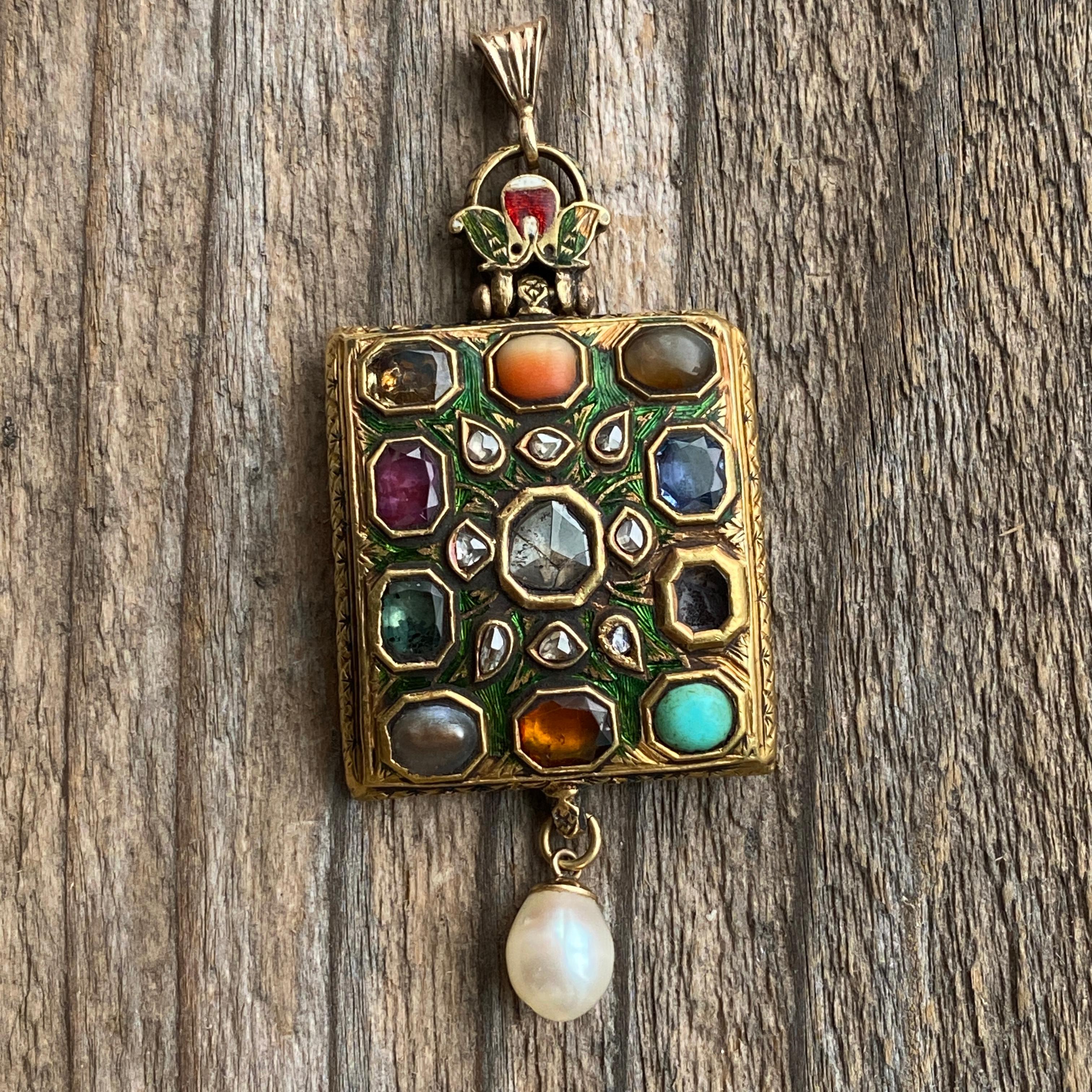 Details:
A stunning unique antique pendant in 22K yellow gold with 11 gemstones, and studded with diamonds, engraved and adorned with enamel work. Originally an armband, and later converted to a pendant. Both sides are adorned, and enameled. The