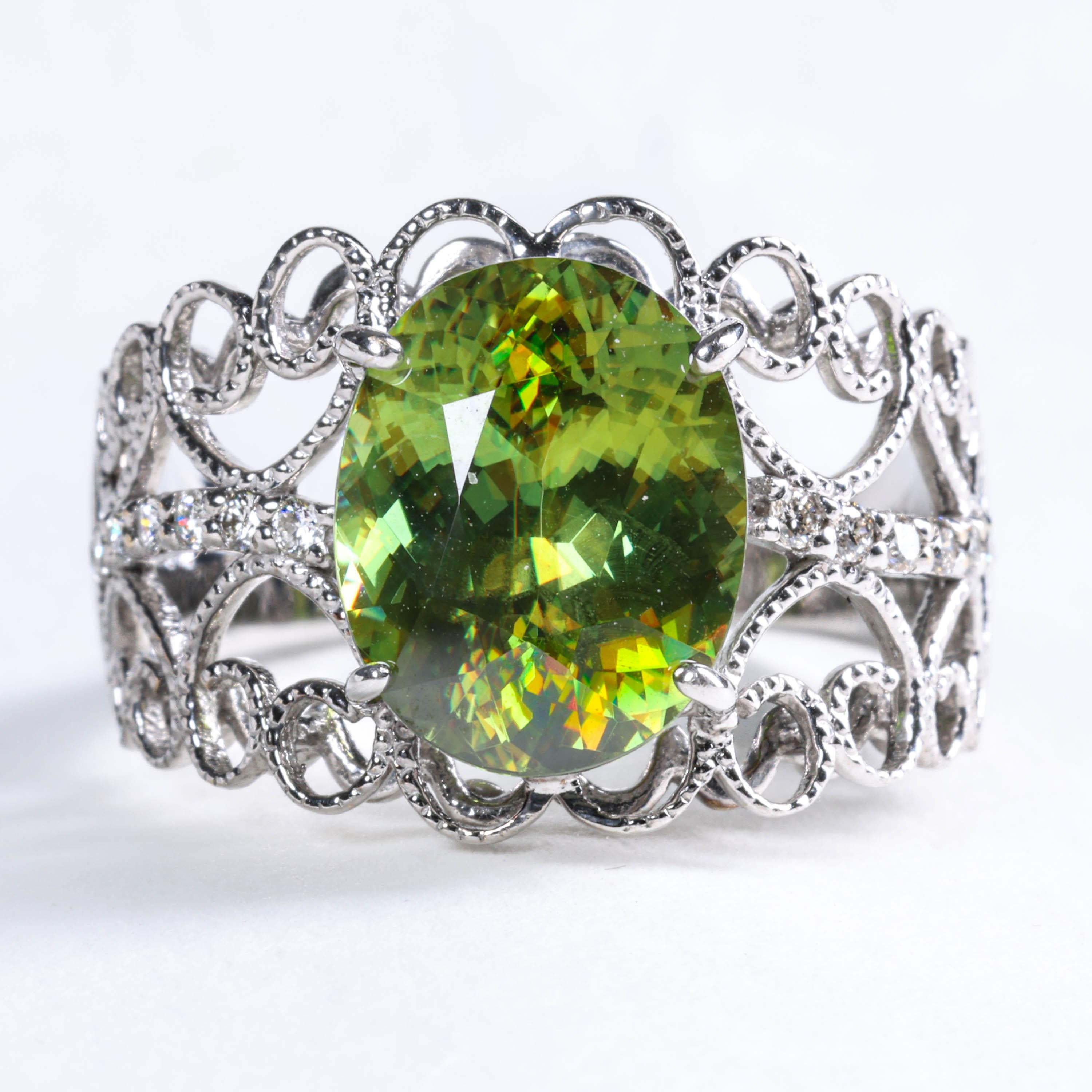 This gorgeous one-of-a-kind ring features a rare gem known by two names: sphene or titanite. From a 3/4 angle in low light, it looks like the finest peridot gem. But add some light and it's fire rivals the finest diamond. Move your hand even the