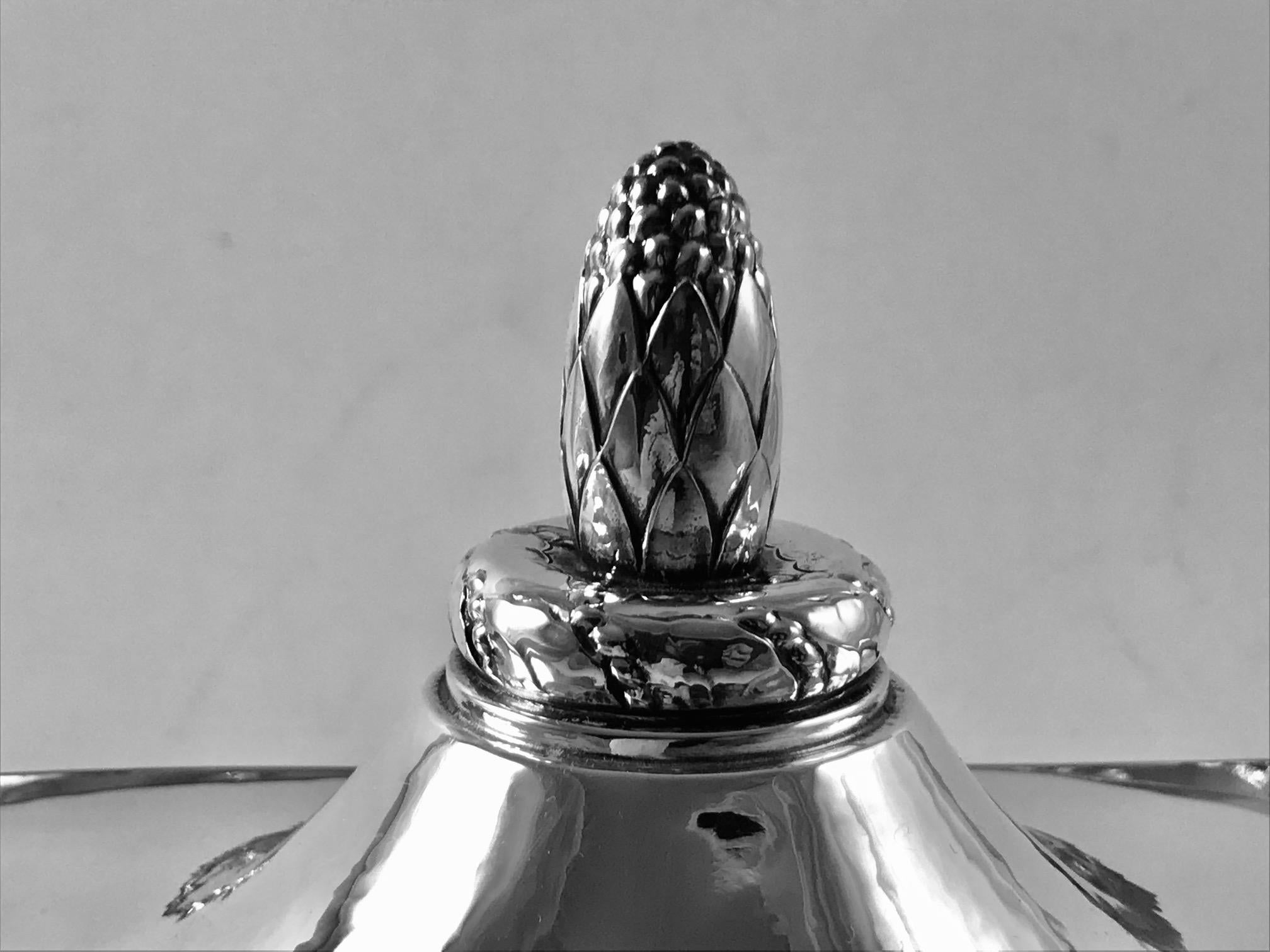 This is a rare Georg Jensen 830 silver bonbonniére raised on a pedestal with pea-pod handles and lid with Acorn finial, design by Georg Jensen.
Measures 8 5/8? across the handles x 4½