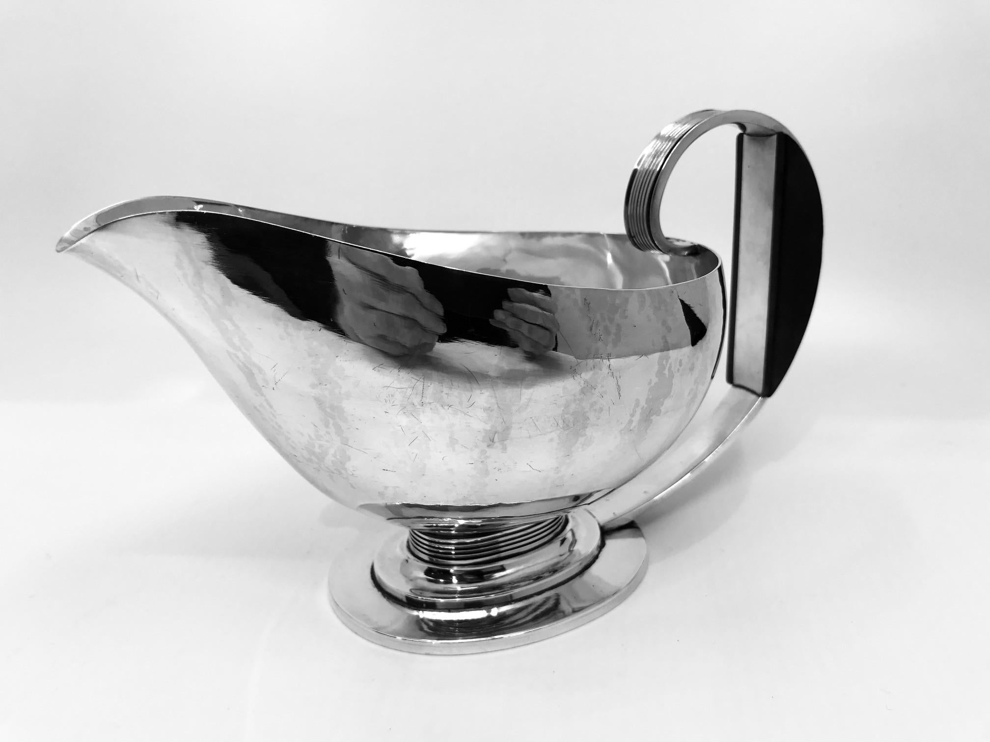 A rare sterling silver Georg Jensen Art Deco sauce boat with ebony handle, design #766 by Gustav Pedersen from 1938. Gustav Pedersen only designed a very few pieces for Georg Jensen, though he worked there from 1915 until his retirement in 1965.