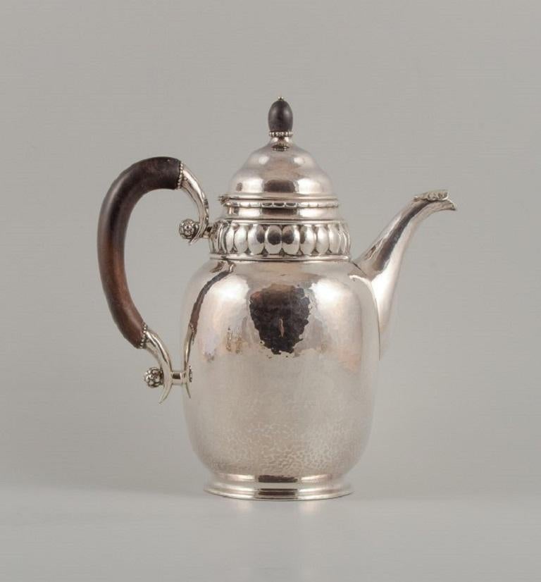 Rare Georg Jensen coffee pot with accompanying creamer and sugar bowl in three-towered silver.
Handle and lid knob of carved ebony. With a hinged lid.
Marked with 1915–1930 mark. Design number 49.
French import marks.
In excellent