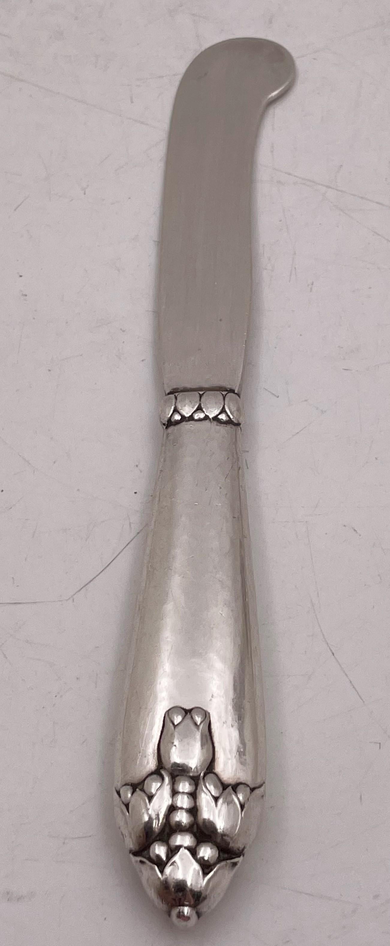 Rare Georg Jensen sterling silver butter spreader, dated 1925 from English hallmarks, with applied natural motifs, measuring 7'' in length by 7/8'' in width, and bearing hallmarks as shown. 

Danish silversmith Georg Jensen (1866-1935) set up his
