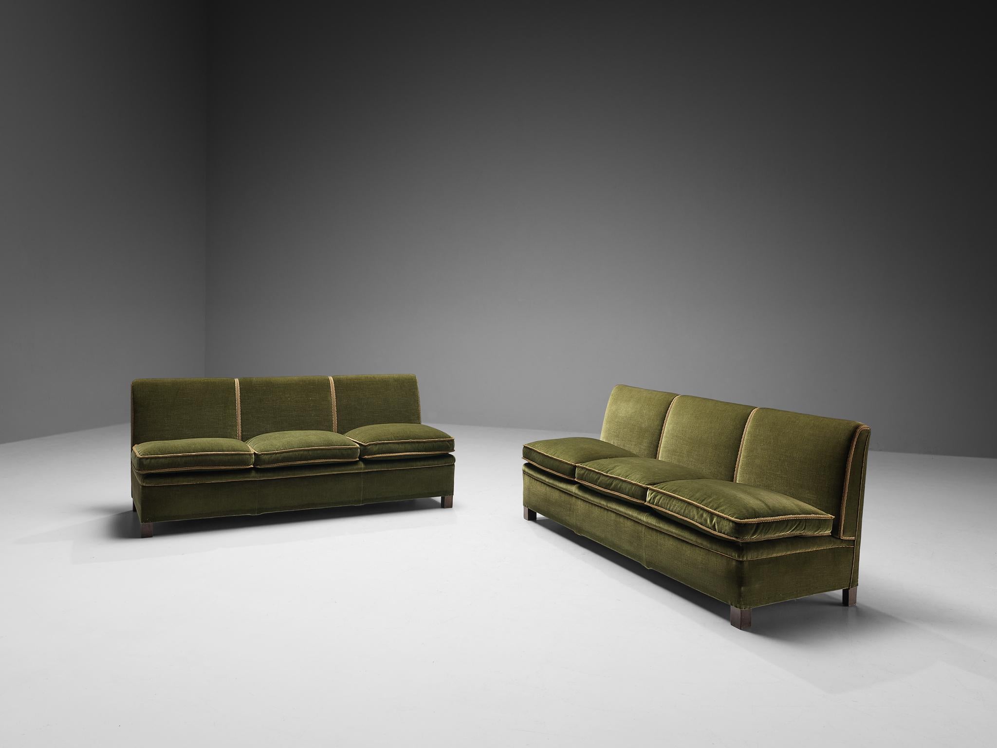 Georg Kofoed for Møbeletabl, pair of sofas, velvet, stained beech, Denmark, circa. 1950. 

This rare pair of sofa is designed by Georg Kofoed has a cozy appeal and is characterized by a splendid construction consisting of two regular three-seat