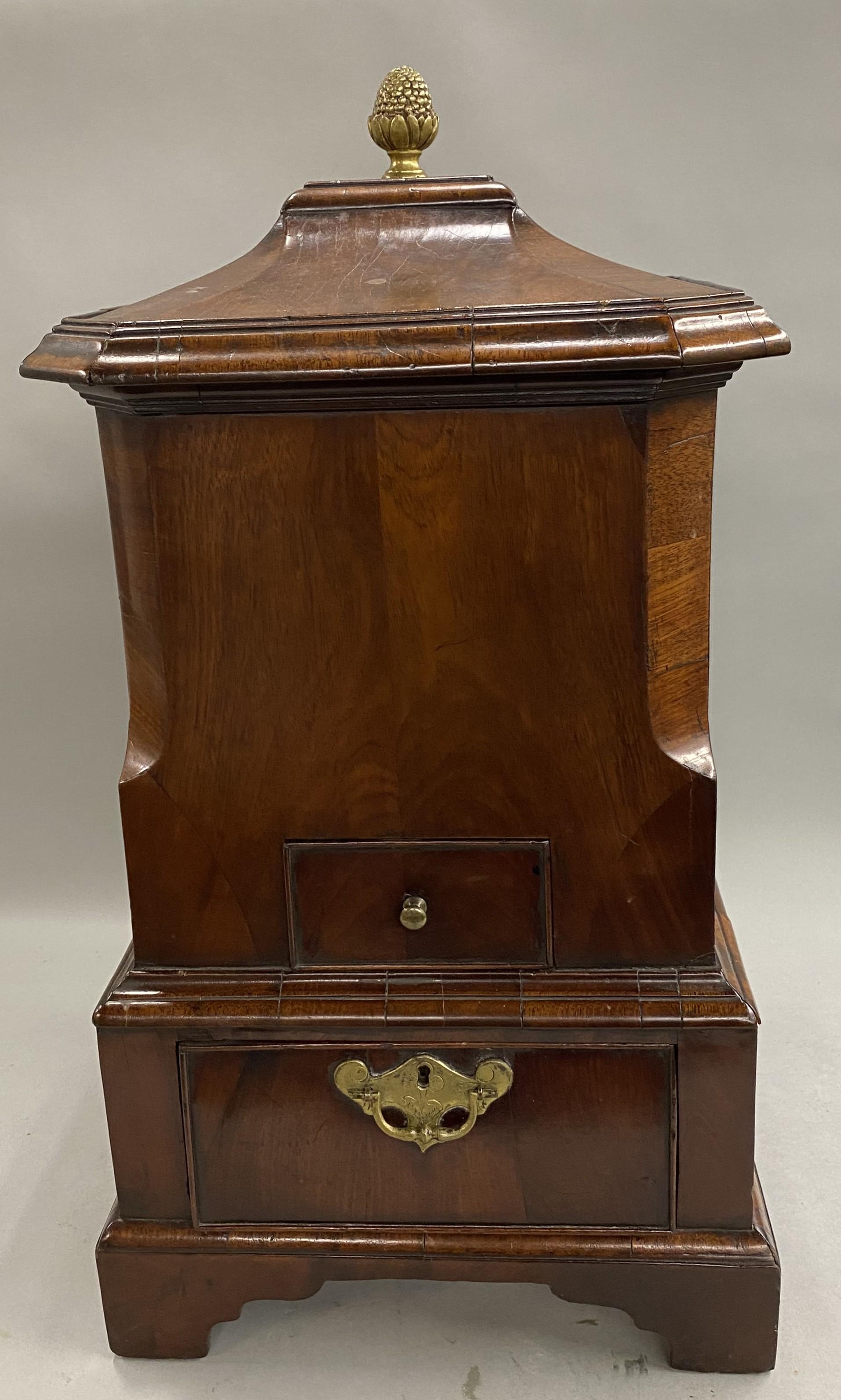 A rare English George II cellarette in the form of a pagoda, with removable top with brass acanthus knop or finial, side handles, and liner, as well as two drawers, and all raised on a bracket base. This cellarette or caddy dates to the 18th century