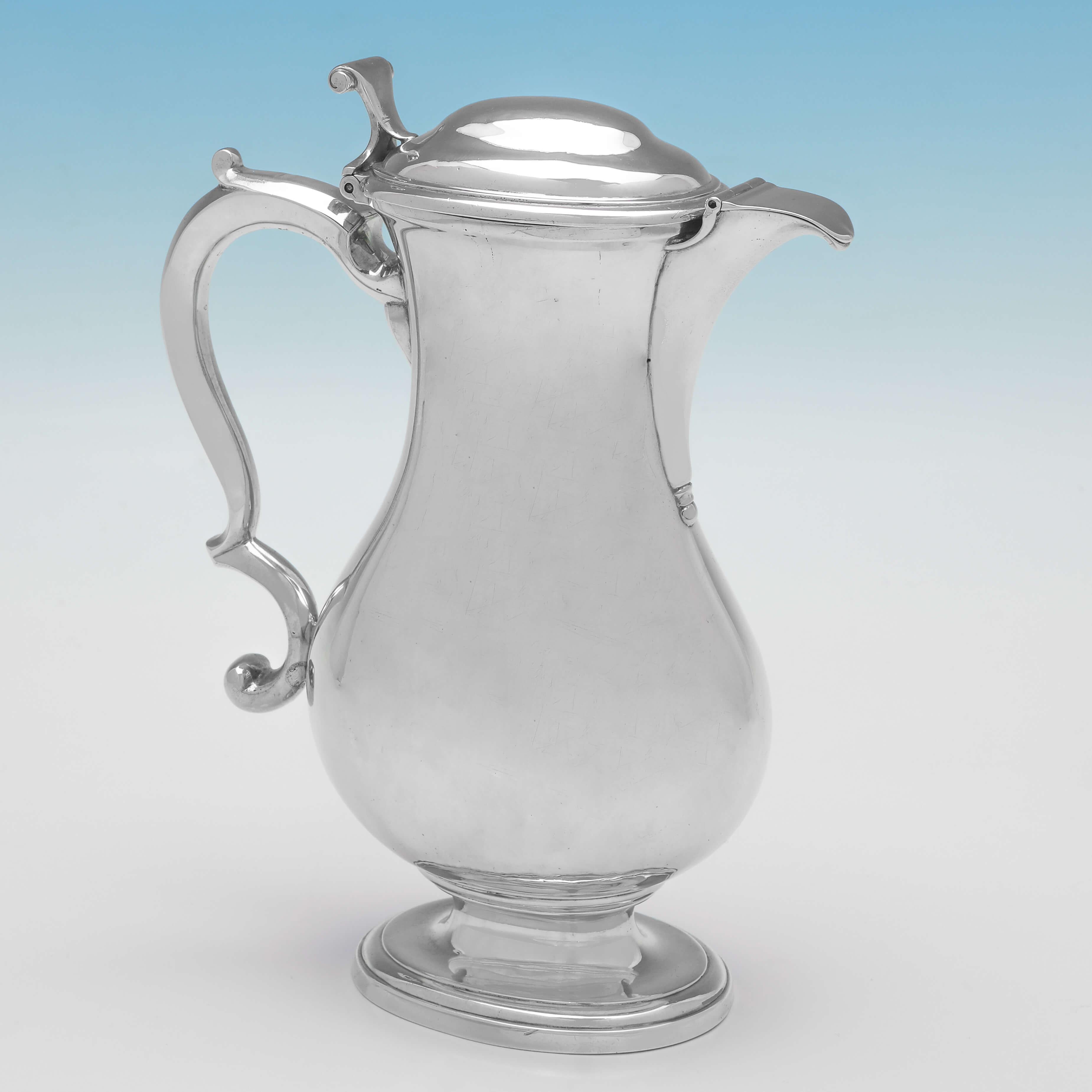Hallmarked in London in 1752 by Paul Crespin, this very fine and rare example of a George II period, antique sterling silver shaving jug, is plain in design, with a flattened baluster shape, a hinged lid and a hinged cover to the spout. 

The