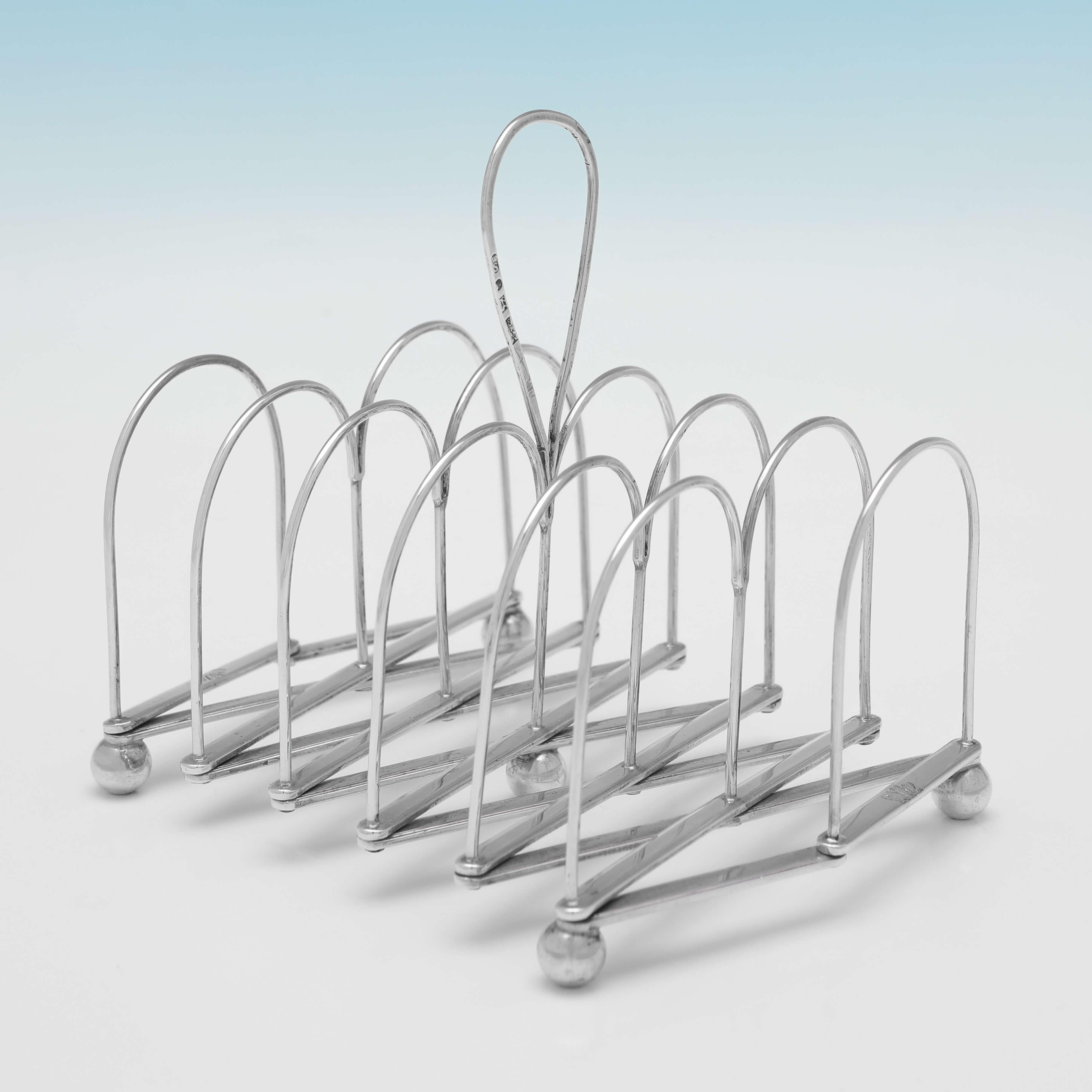 Hallmarked in Sheffield in 1807 by Roberts, Cadman & Co., this very handsome, and rare to find, Antique Sterling Silver Extending Toast Rack, is plain in design, and stands on four ball feet. 

The toast rack measures 5.5