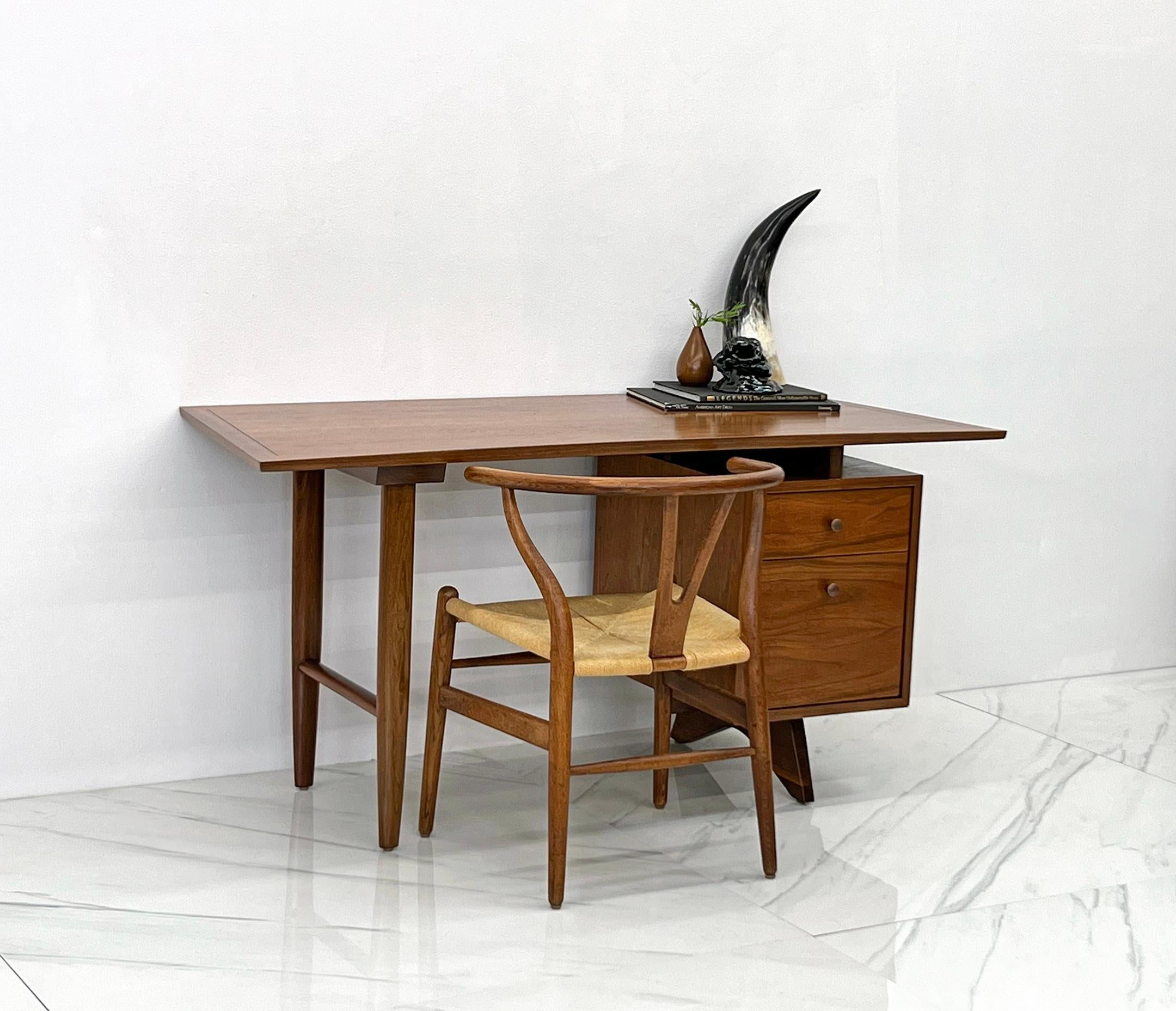 This desk is incredible-- and rare. So rare, we could find only one of these desks to ever come to market, and that was nearly a decade ago. This single pedestal, walnut desk was designed by George Nakashima as part os his Origins collection for